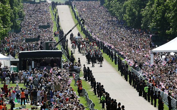 Prince Harry, Duke of Sussex and Meghan, Duchess of Sussex wave from the Ascot Landau Carriage during their carriage procession after their wedding at St George's Chapel on May 19, 2018, after their wedding ceremony. | Source: Getty Images.