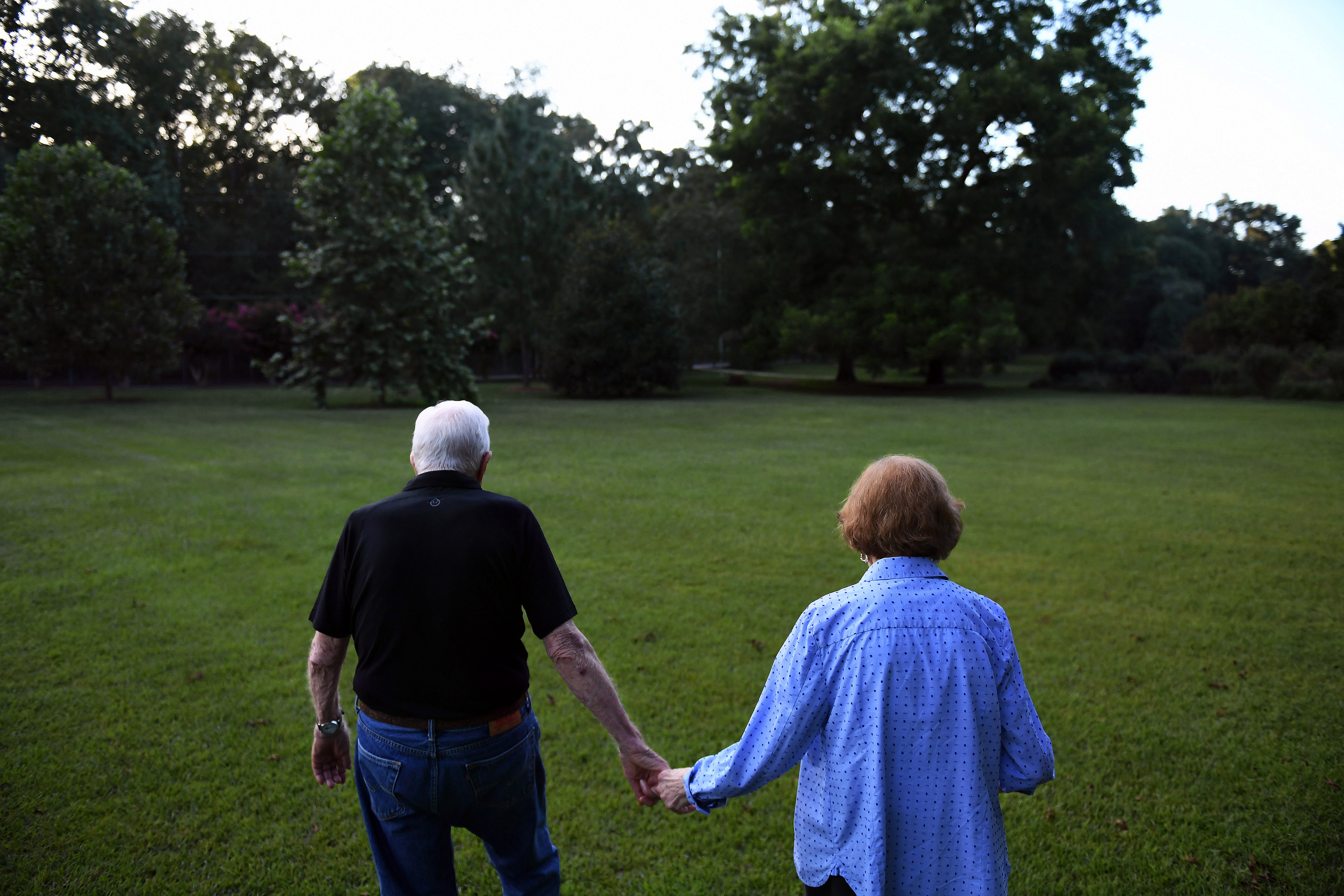 Former U.S. President Jimmy Carter and former U.S. First Lady Rosalynn Carter walking back home from dinner at a friend's house in Plains, Georgia on August 4, 2018 | Source: Getty Images