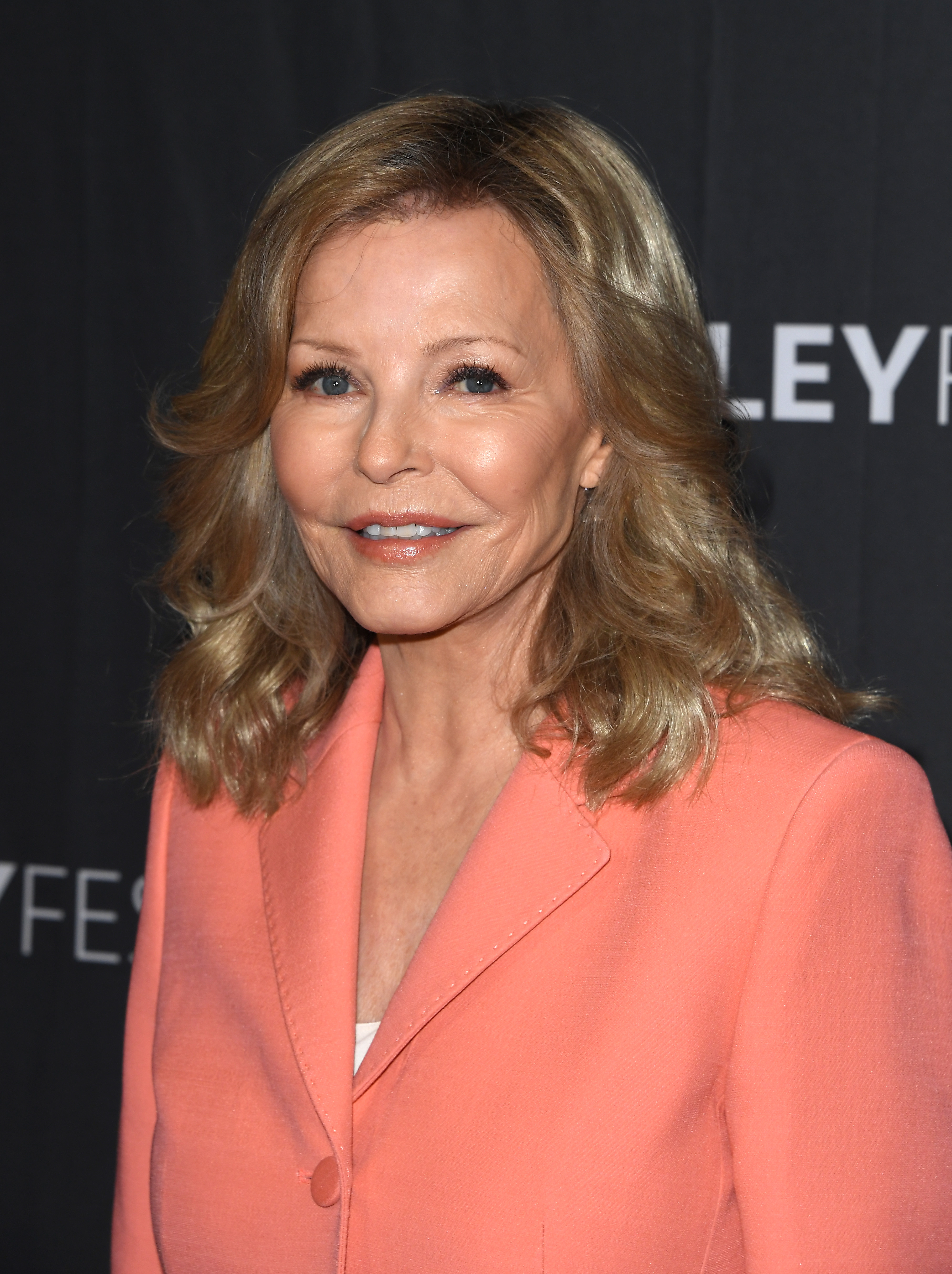 Cheryl Ladd arrives at PaleyFest LA in Hollywood on April 6, 2026, wearing a coral blazer and soft waves, offering a warm smile as she celebrates a milestone moment in television history.