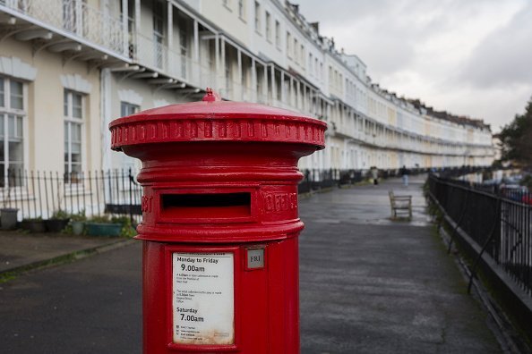A Royal Mail postal box and a background of terraced homes on Royal York Crescent, on 26th December 2019, in Clifton, Bristol, England | Photo: Getty Images
