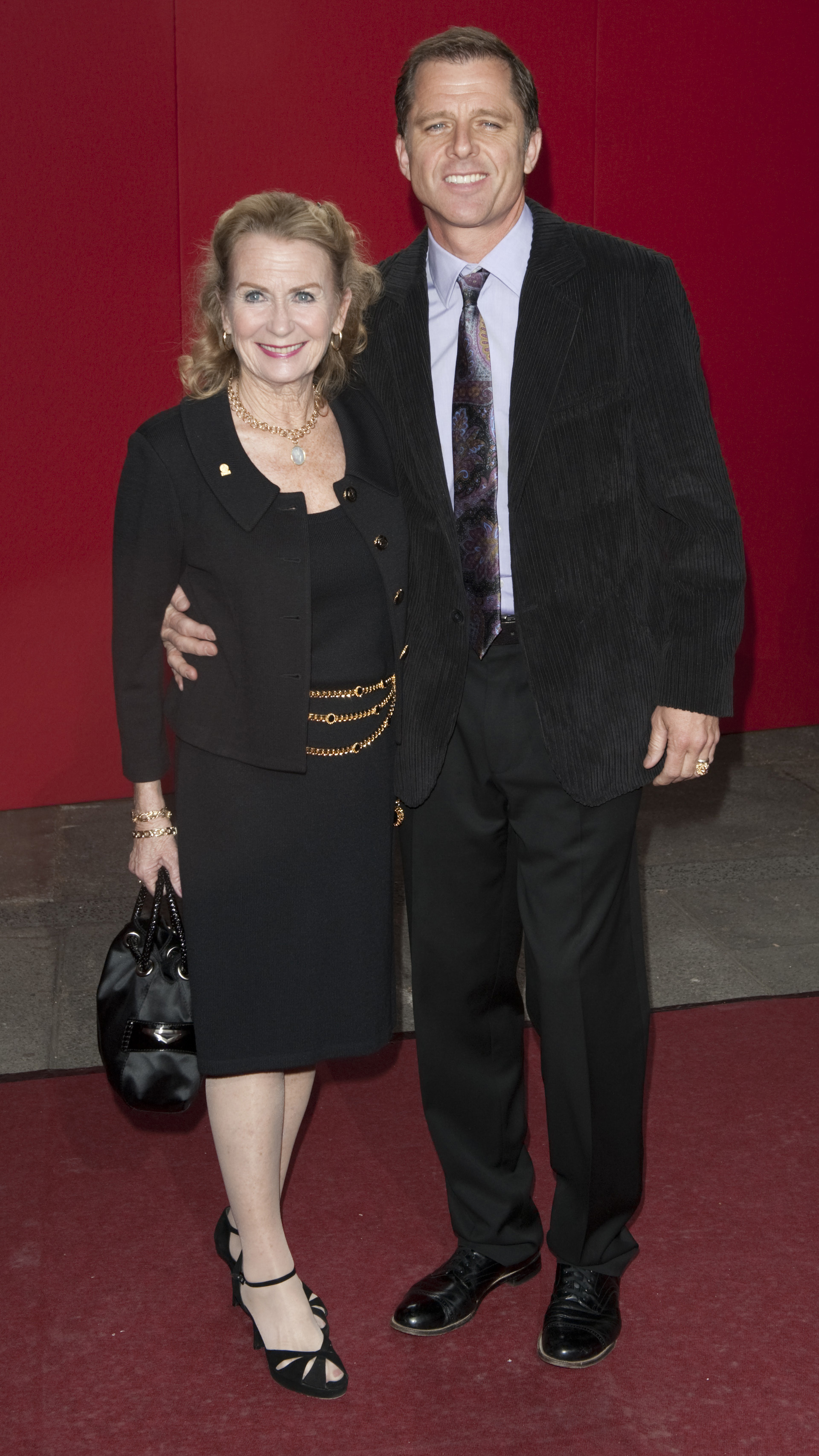 The actress and Maxwell Caulfield arrive for the 2009 British Soap Awards in Wood Lane, London. | Source: Getty Images