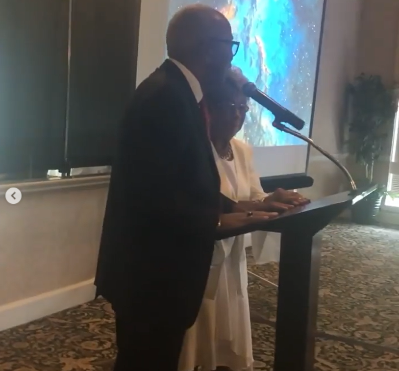 Thomas and Shirley Williams speak at a podium during the 100th birthday celebration of Courtney Brown's grandmother | Source: Instagram/thinkbiggie