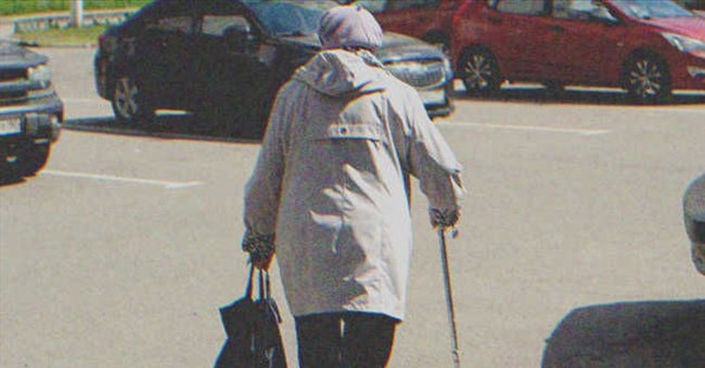 An old lady walking in a parking lot | Source: Shutterstock