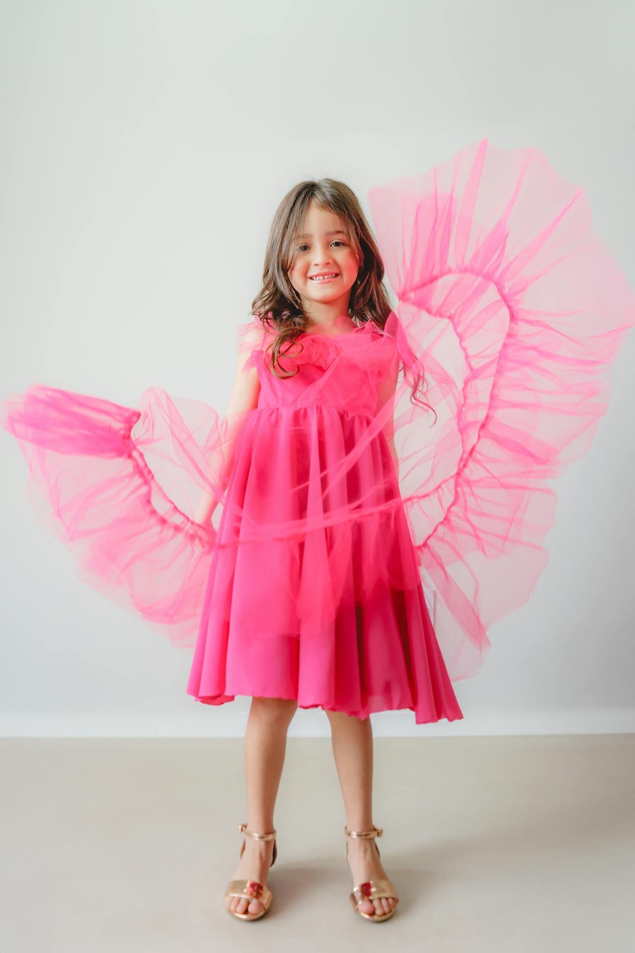 Excited little girl in her pink dress | Source: Pexels