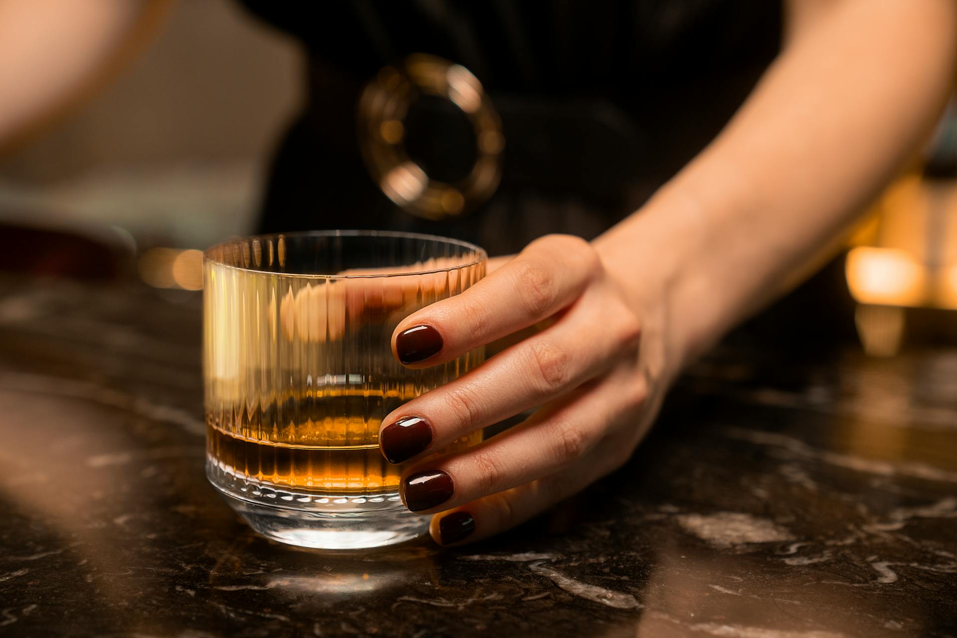 A woman holding a drink | Source: Pexels