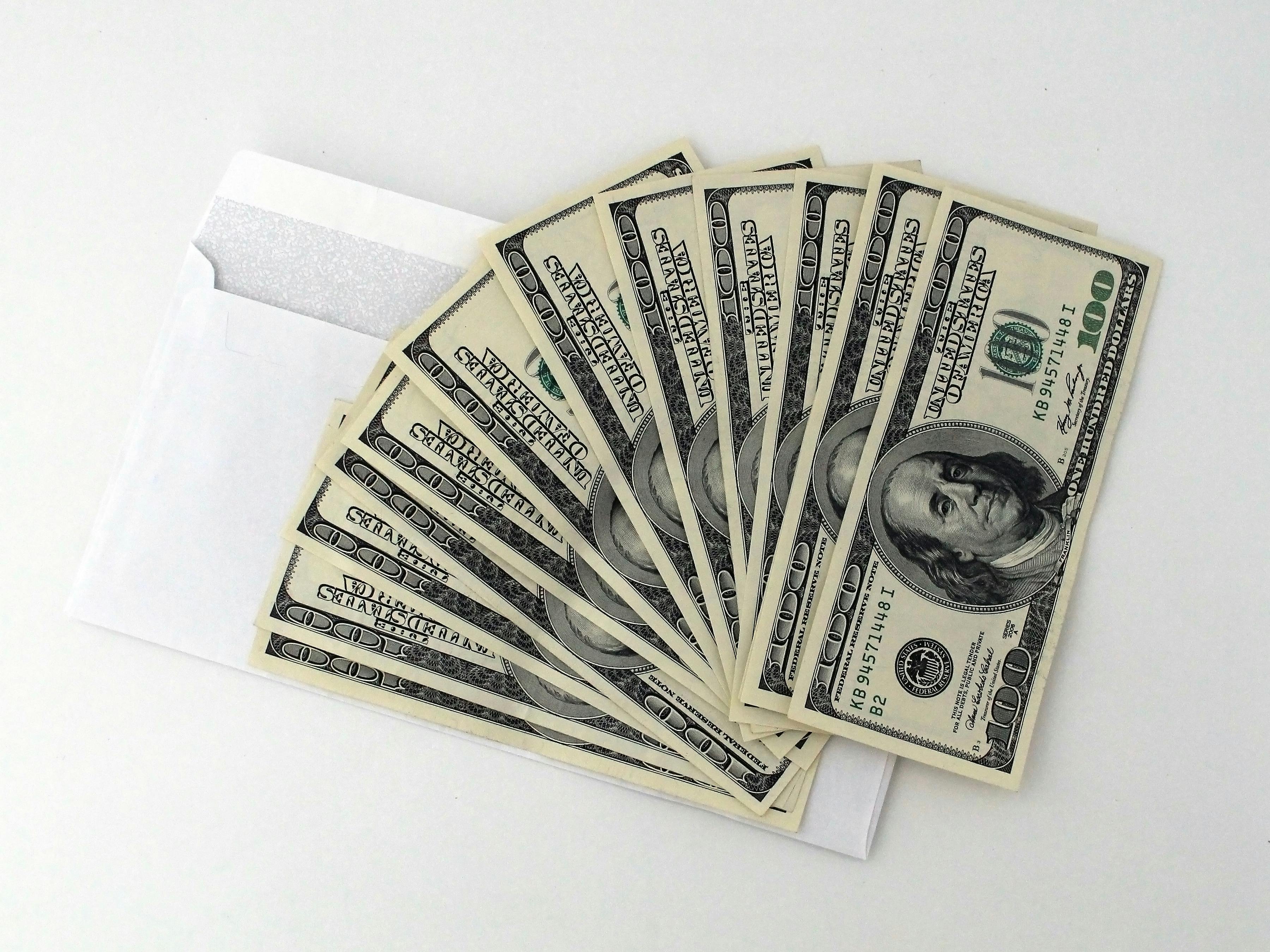 Several dollar bills on an envelope | Source: Pexels