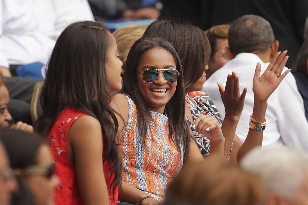 Malia Obama, Sasha Obama, U.S. first lady Michelle Obama and President Barack Obama react to the first run scored during an exhibition game between the Cuban national baseball team and Major League Baseball's Tampa Bay Devil Rays at the Estado Latinoamericano in Havana, Cuba | Photo: Getty Images