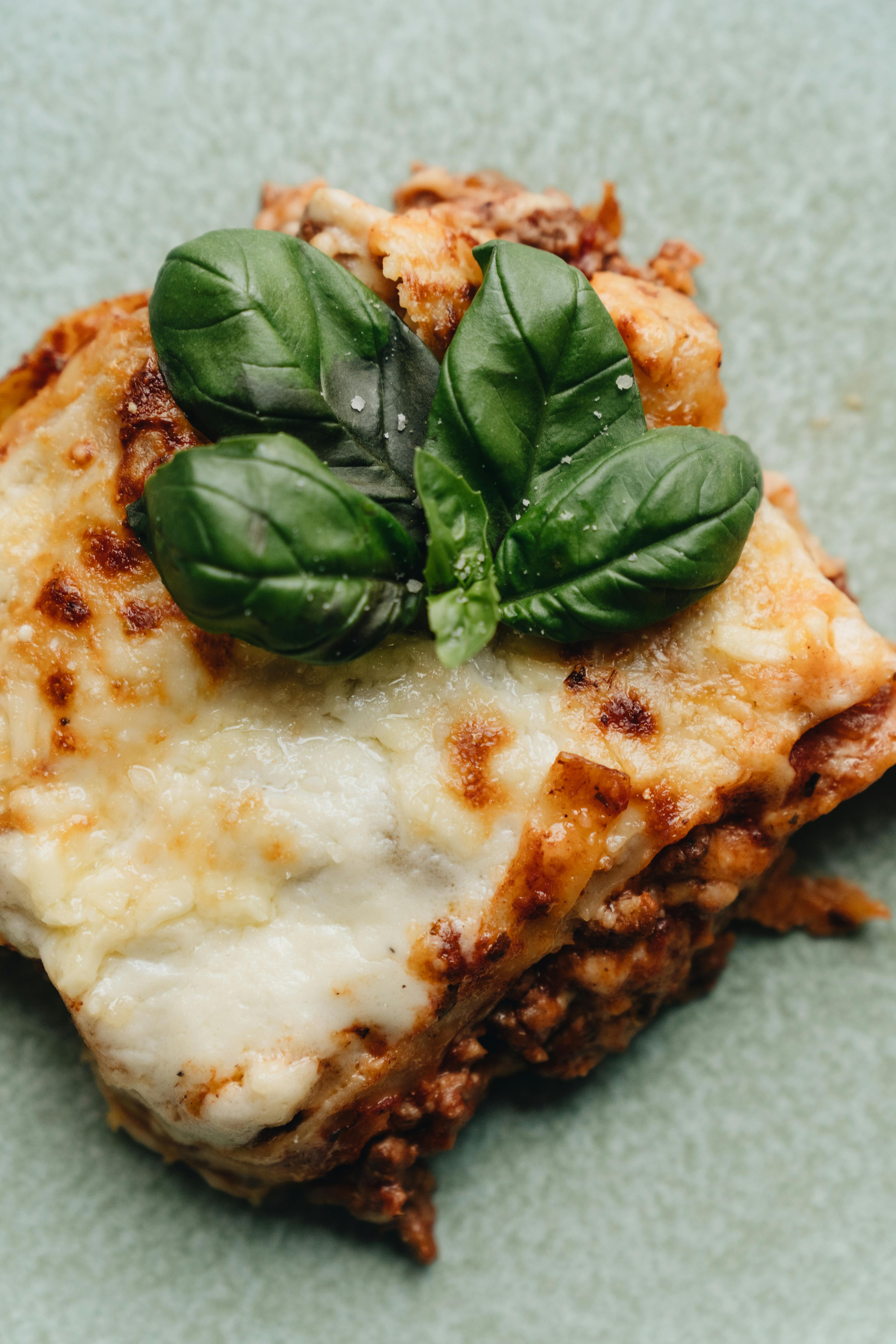 A slice of lasagna garnished with basil | Source: Pexels