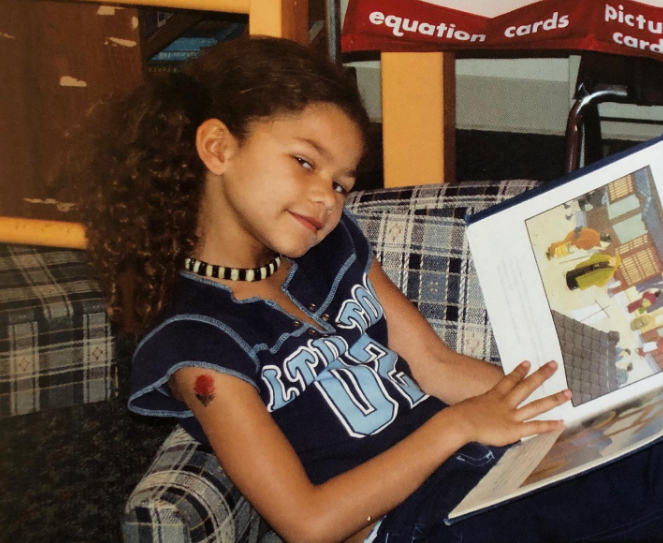 Sadly, the pressure became a lot for a child. In this photo, she posed on a couch while reading a children's book in a throwback image uploaded on September 2, 2019. | Source: Instagram/zendaya