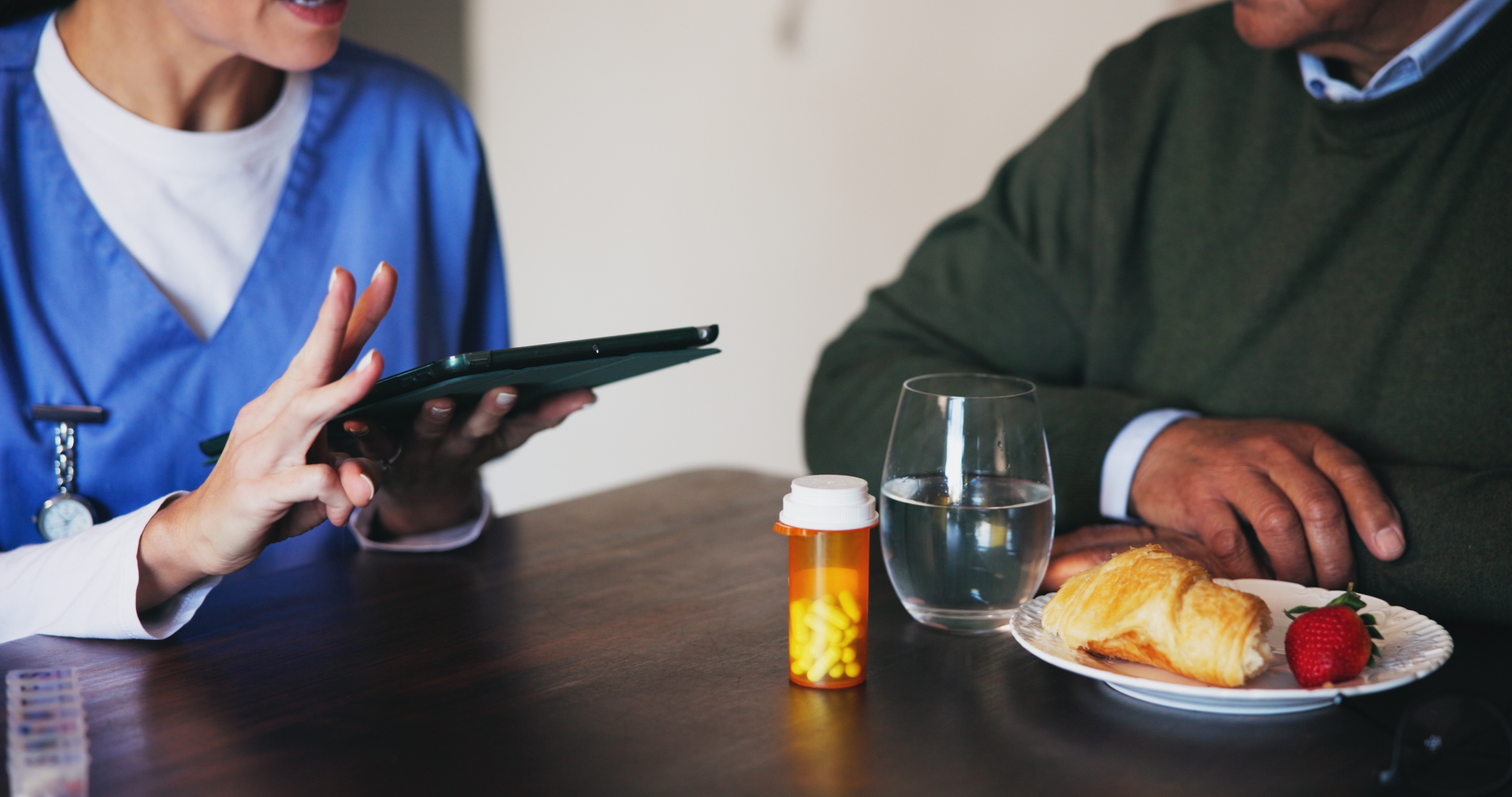 Nurse conversing with a man | Source: Shutterstock