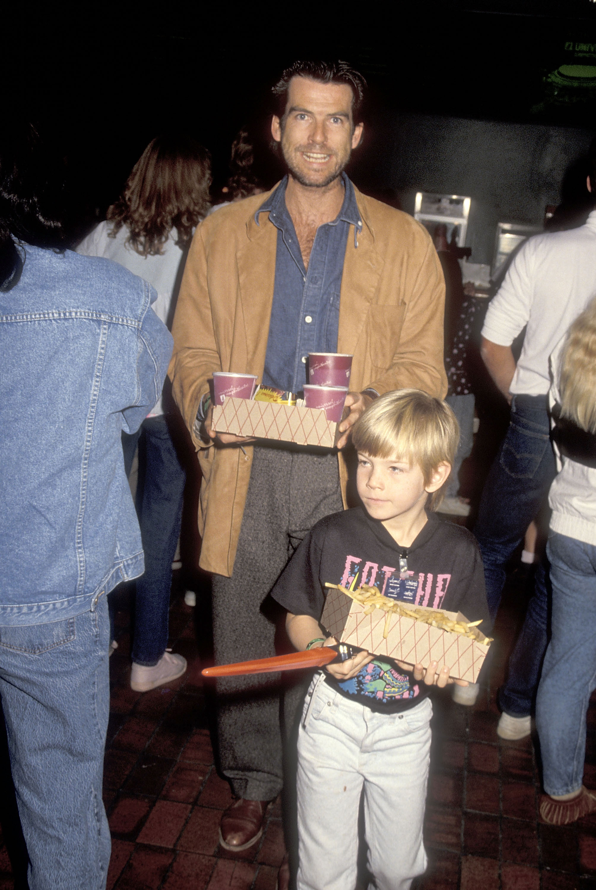 Pierce and Sean Brosnan at the rock and roll tour of the Teenage Mutant Ninja Turtle's "Coming Out of Their Shells" on November 21, 1990 in California | Source: Getty Images