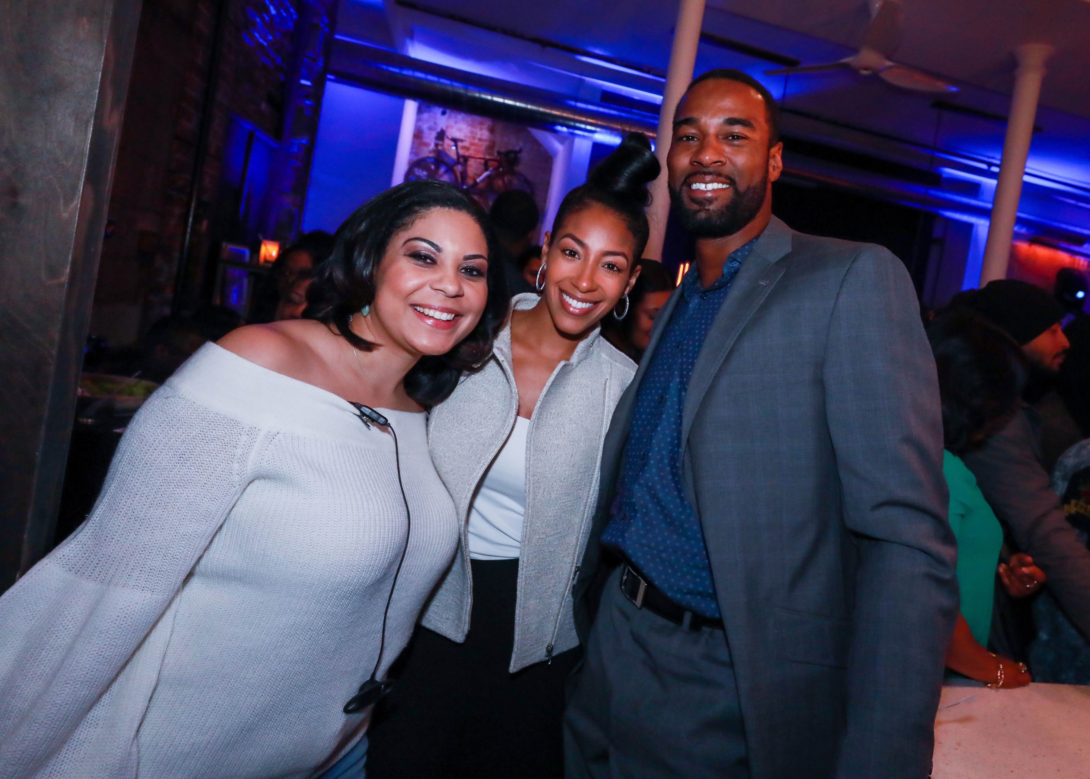 A guest, Brittney McNorton, and Calvin Johnson Jr. pose at the H.O.M.E. by Martell event on November 29, 2017, in Detroit, Michigan. | Source: Getty Images