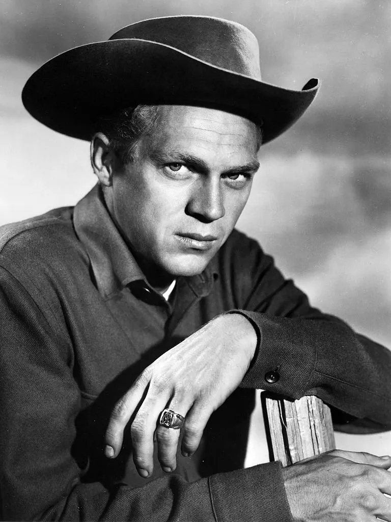 Portrait of American actor Steve McQueen (1930 - 1980) (as Josh Randall), perched atop a fence, in the television series 'Wanted: Dead or Alive,' late 1950s or early 1960s. | Source: Getty Images