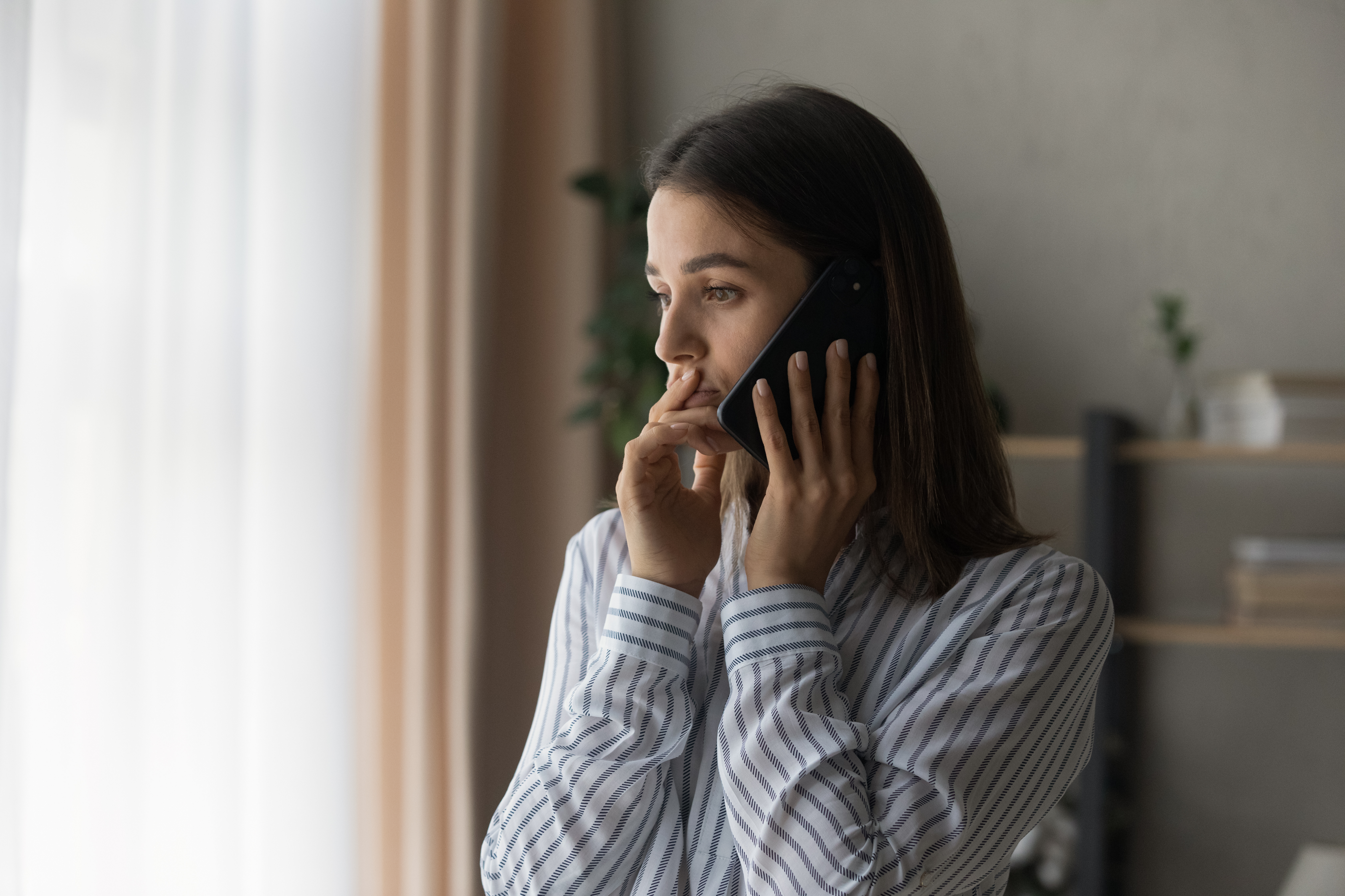 A young woman on the phone | Source: Shutterstock