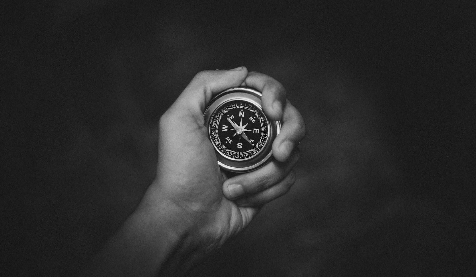 A person holding a round analog compass | Source: Pexels