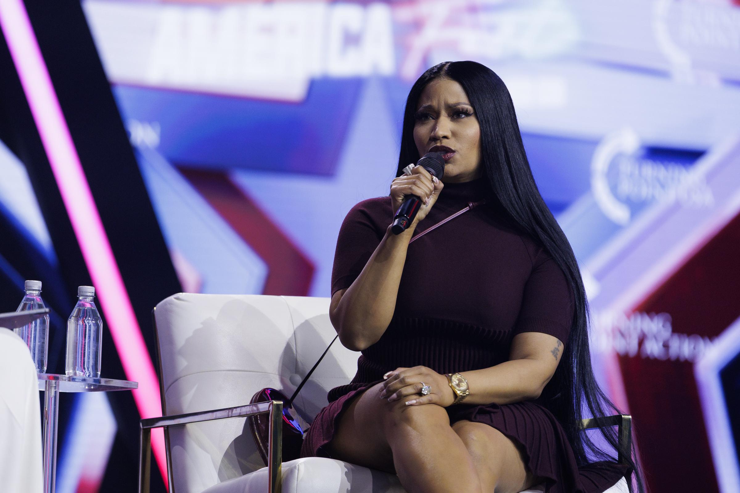 Nicki Minaj being interviewed by Erika Kirk on the final day of Turning Point USA's annual America Fest conference in Phoenix, Arizona on December 21, 2025. | Source: Getty Images