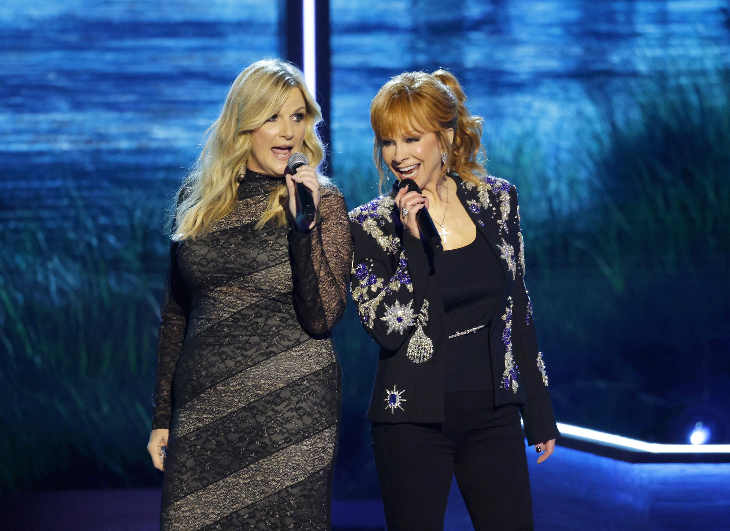 Trisha Yearwood and Reba McEntire perform onstage during Opry 100: A Live Celebration  at Grand Ole Opry on March 19, 2025 in Nashville, Tennessee | Source: Getty Images