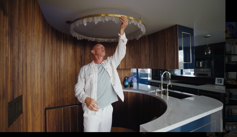 A renovation delay helped inspire one of the home's quirkiest design combinations: fluted walnut and a circular crystal-trimmed fixture. Christopher even joked that nearby magnetized crystals help him align his chakras. | Source: YouTube/Architectural Digest