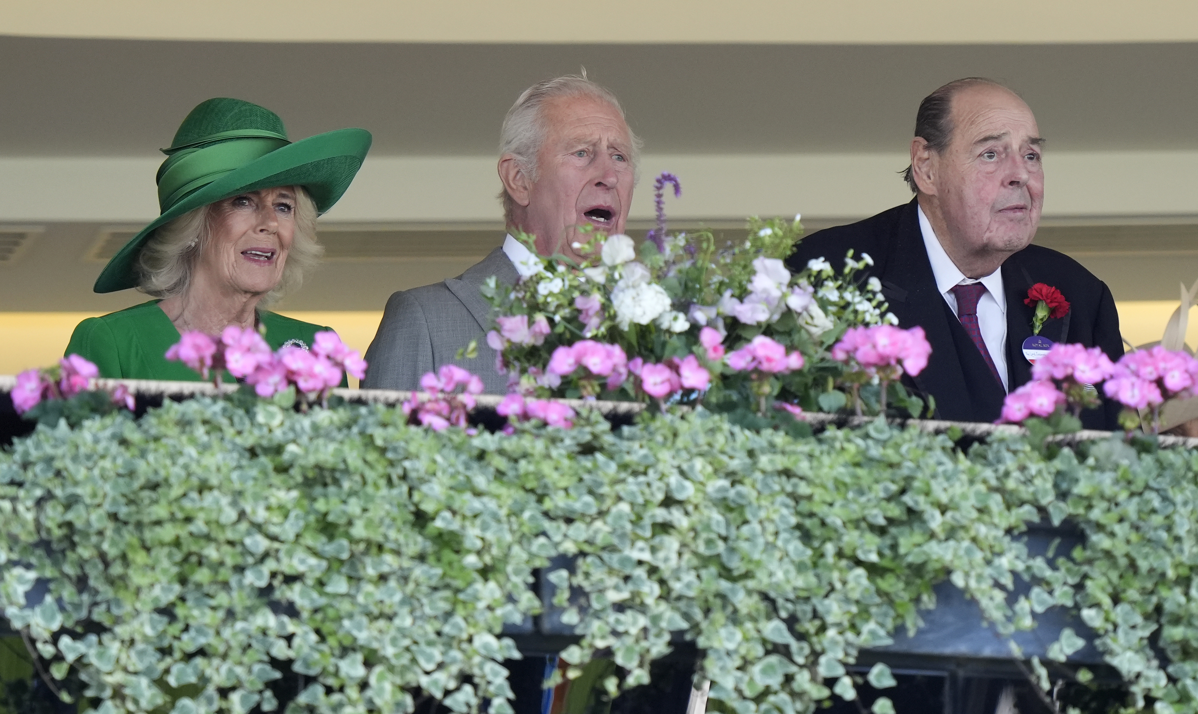 Queen Camilla, King Charles III, and Lord Nicholas Soames of Fletching look on from the royal box as they watch the Kensington Palace Stakes unfold at Royal Ascot in Berkshire.