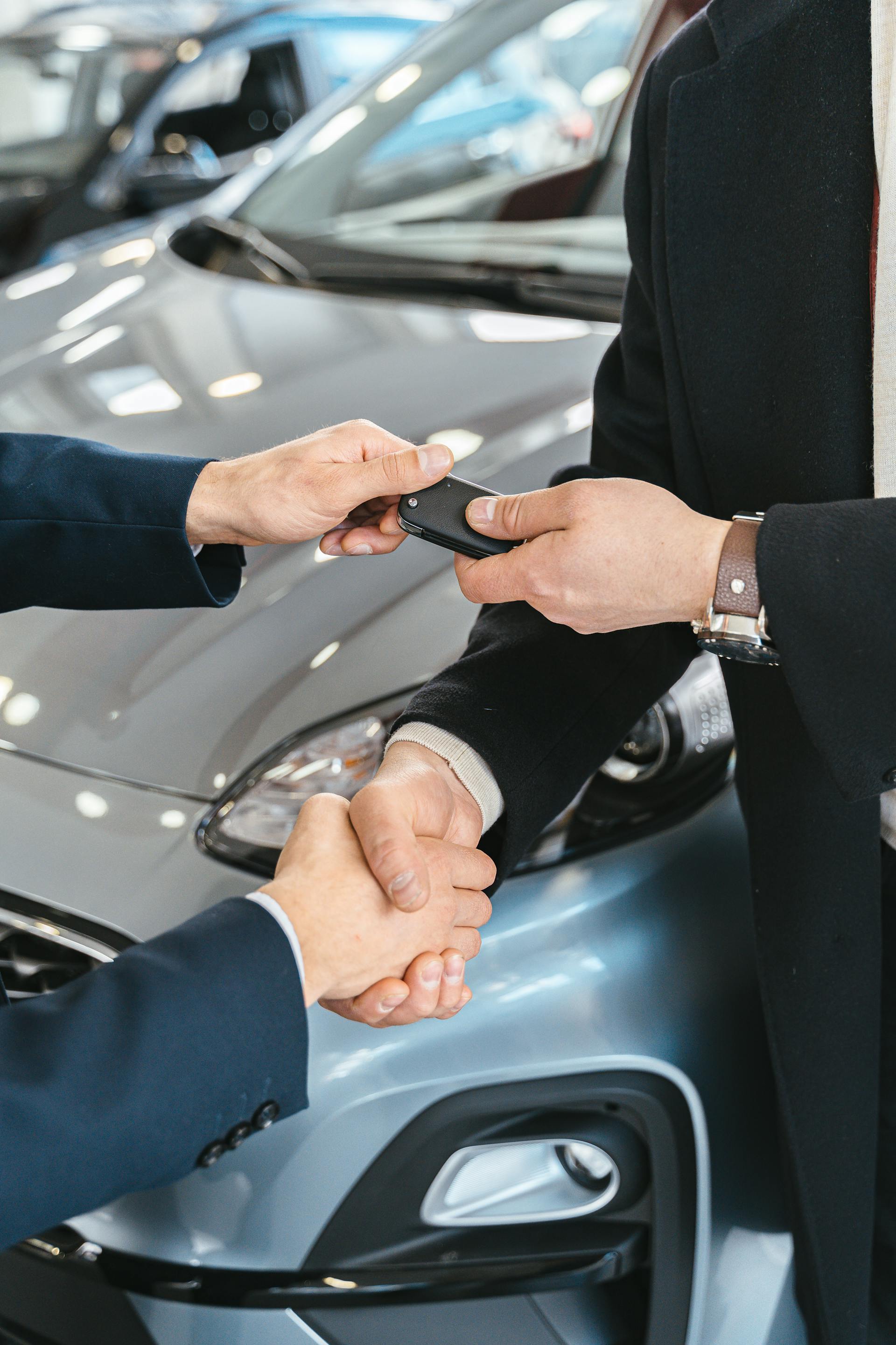 Close-up of men shaking hands at a new car sale | Source: Pexels