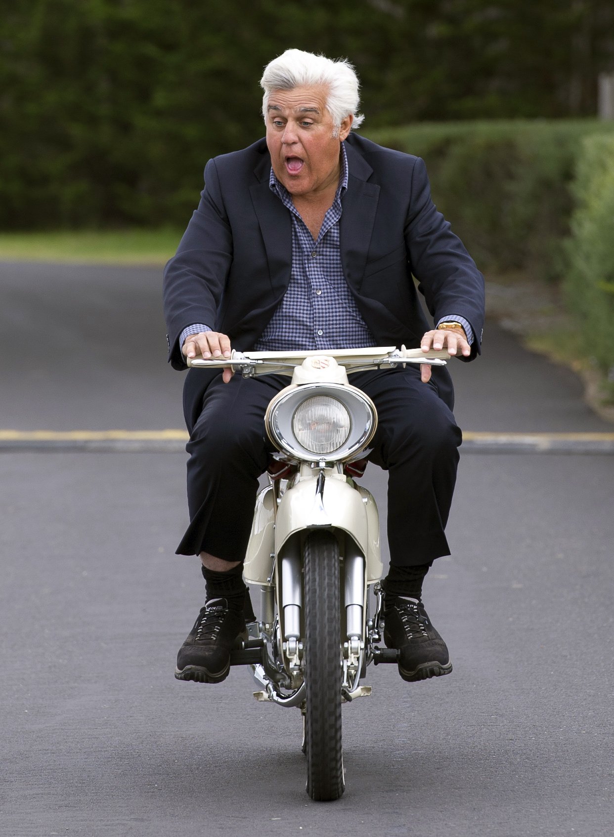 Jay Leno rides a 1964 Zweirad Union Kavalier Type 115 motorcycle during the 2014 Pebble Beach Concours d'Elegance in Pebble Beach, California on August 17, 2014 | Source: Getty Images