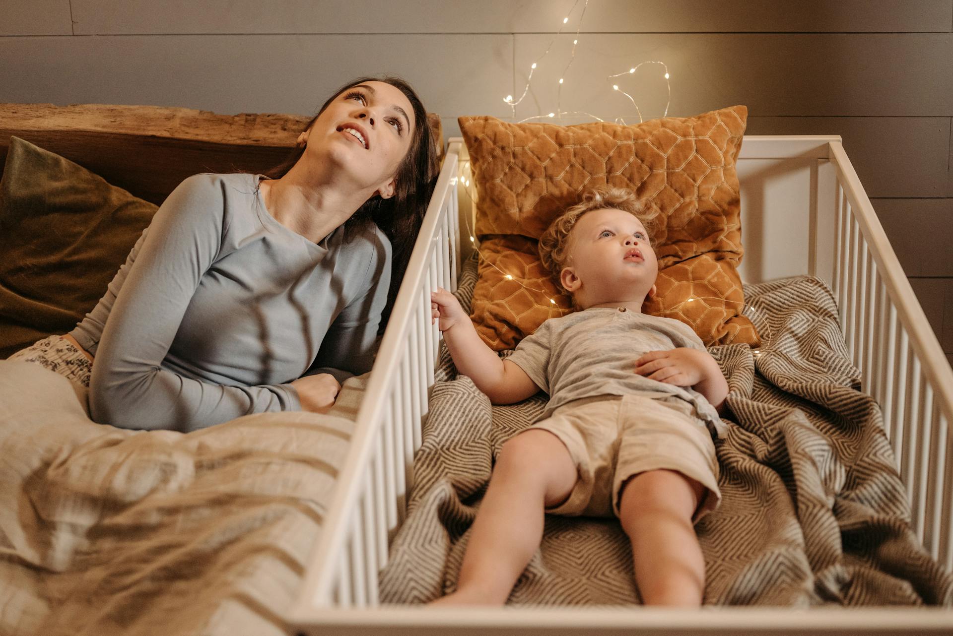 A woman and her son looking at the ceiling at night | Source: Pexels