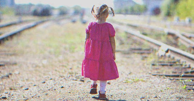 Little girl walking by the railroad | Source: Shutterstock