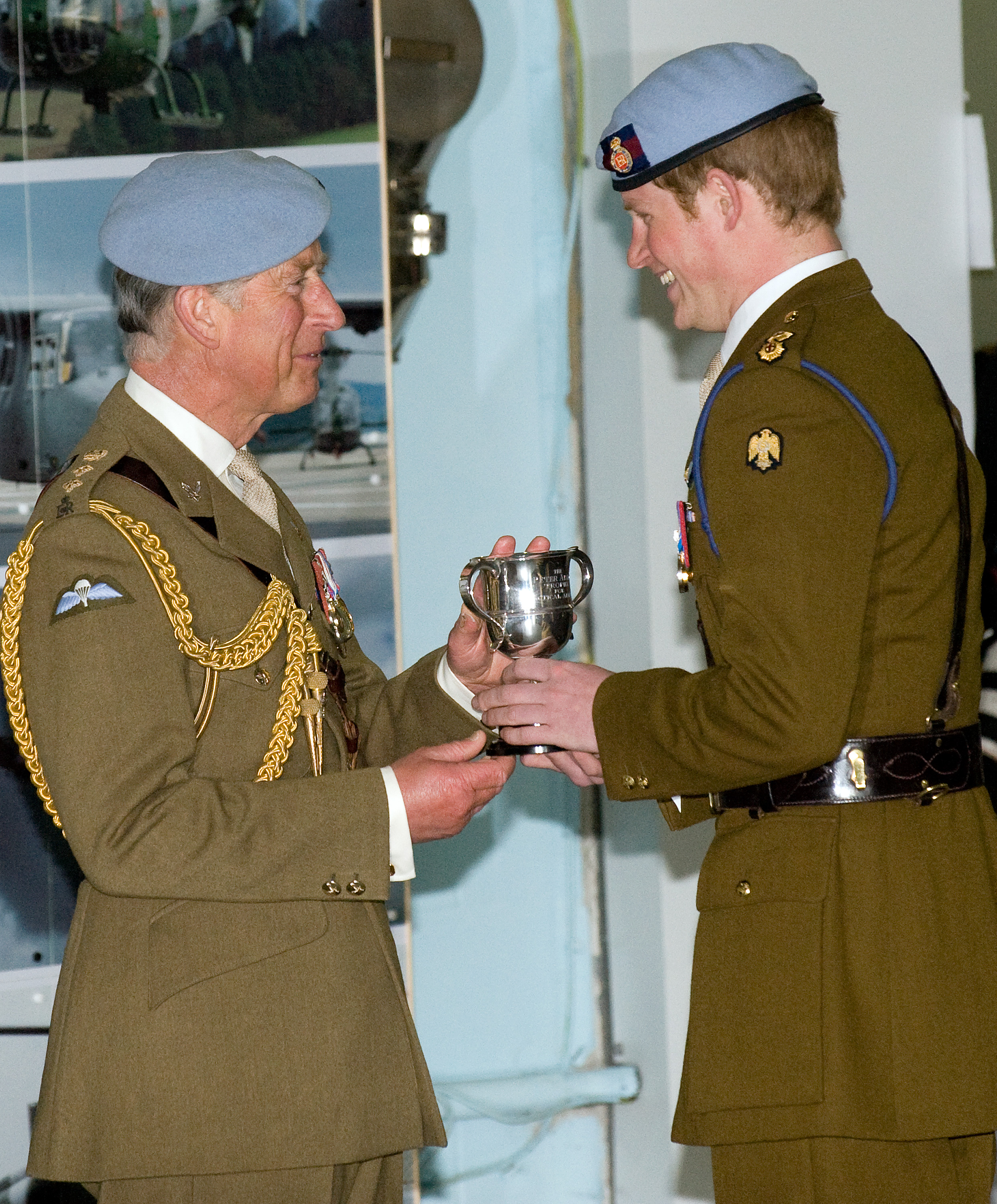 Prince Charles, Prince of Wales presents Prince Harry with his flying badges in Middle Wallup, England on May 7, 2010. | Source: Getty Images