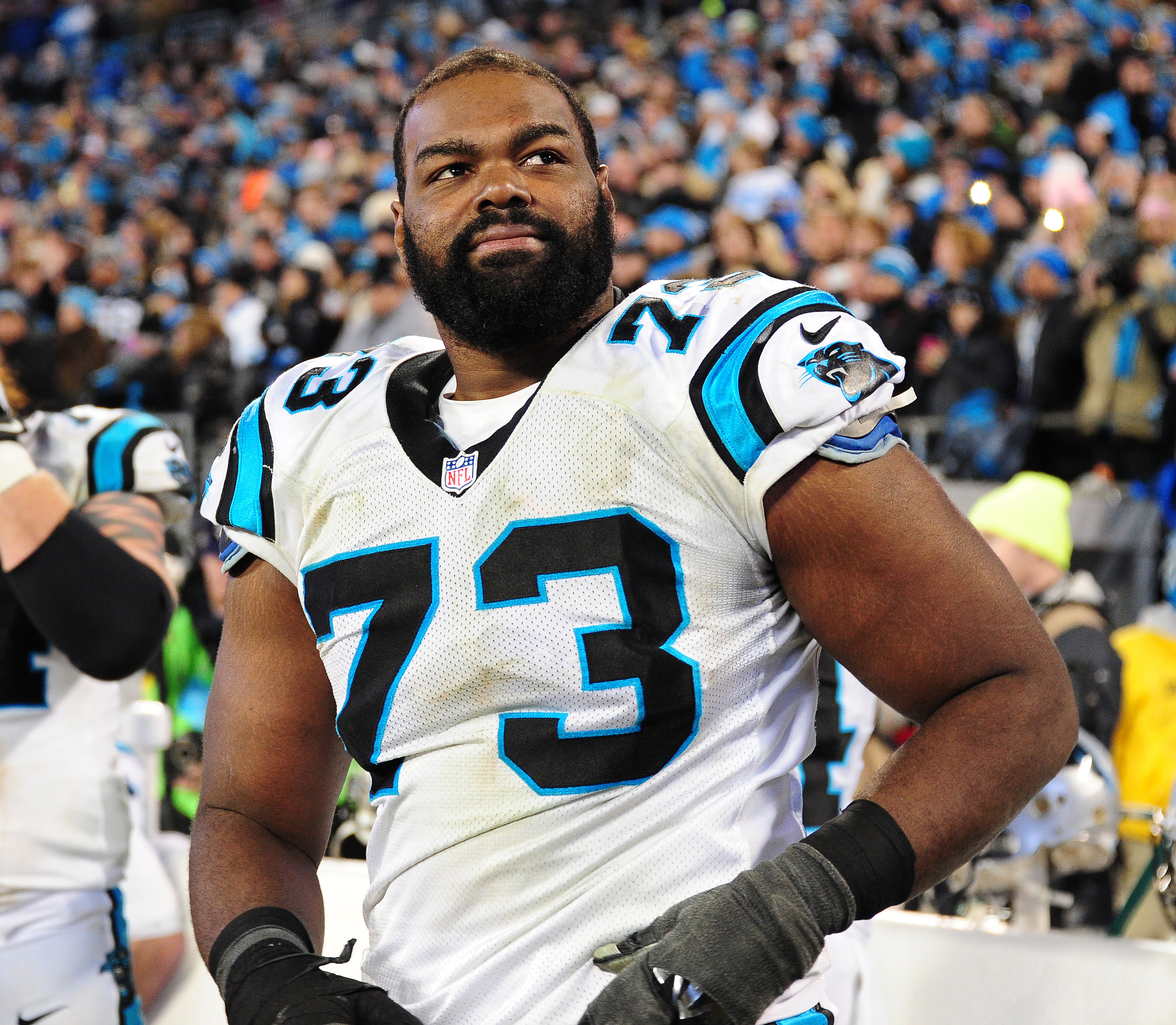 Michael Oher of the Carolina Panthers watches play against the Arizona Cardinals during the NFC Championship Game on January 24, 2016, in Charlotte, North Carolina. | Source: Getty Images