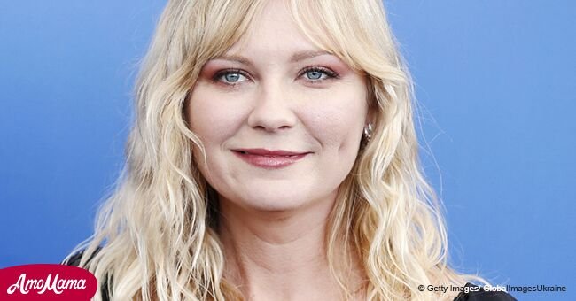 Kirsten Dunst flashes her huge baby bump in a loose black midi dress during recent outing