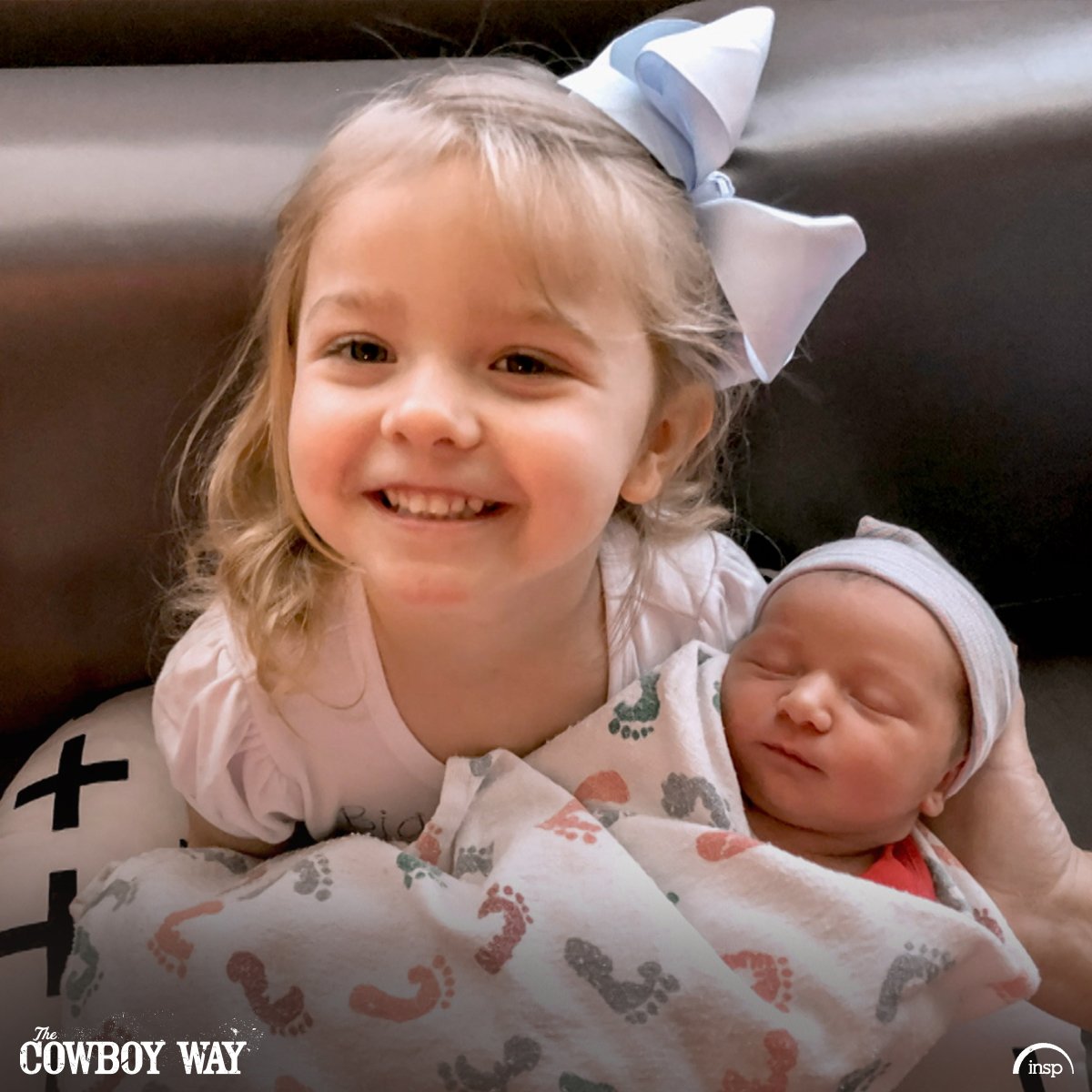 Bubba and Kaley Thompson's daughter holds her baby brother while posing for a photograph. | Source: INSP