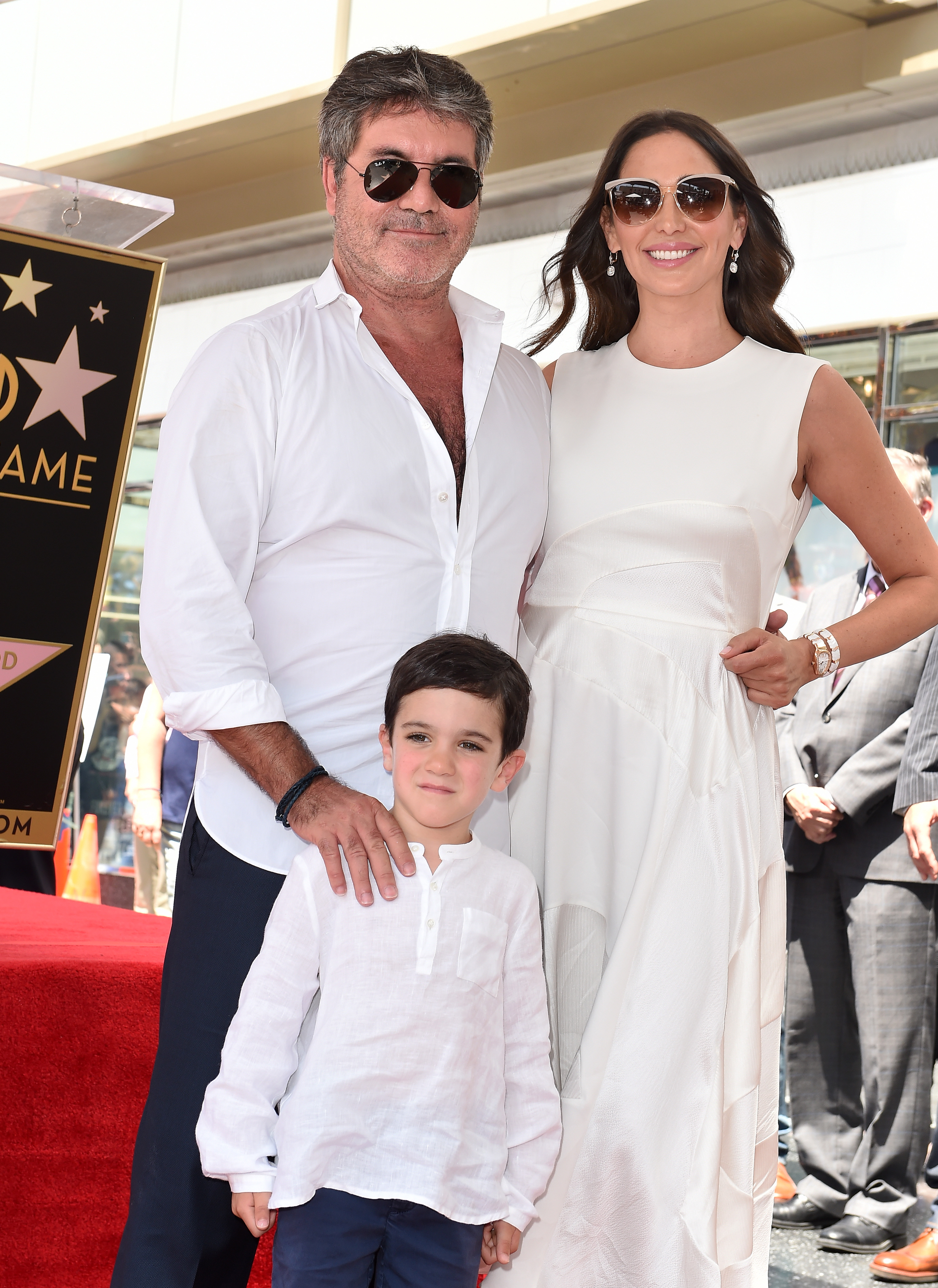 Simon and Eric Cowell with Lauren Silverman at Simon's Star on the Hollywood Walk of Fame ceremony on August 22, 2018, in California. | Source: Getty Images