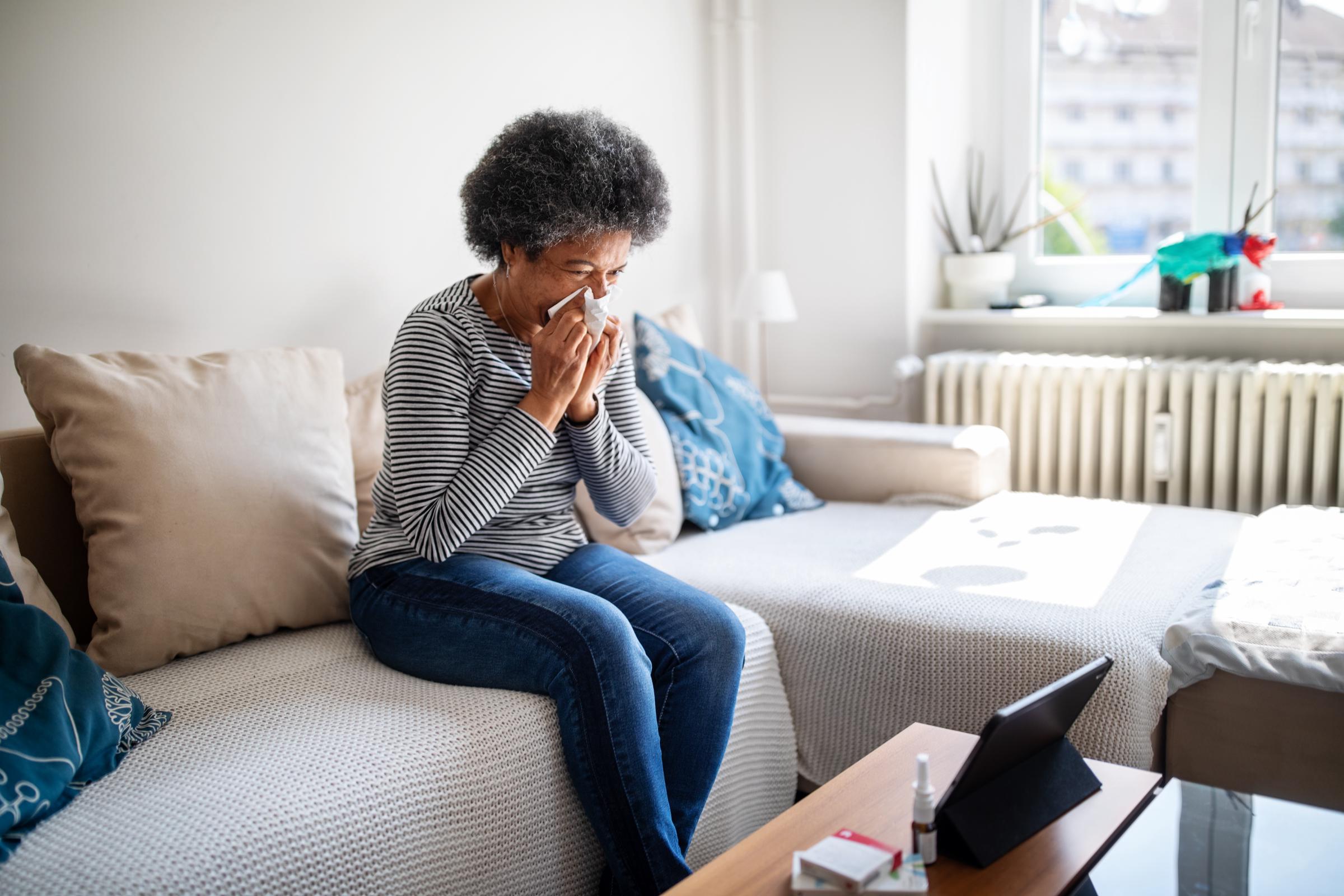 An older woman wiping her nose | Source: Getty Images