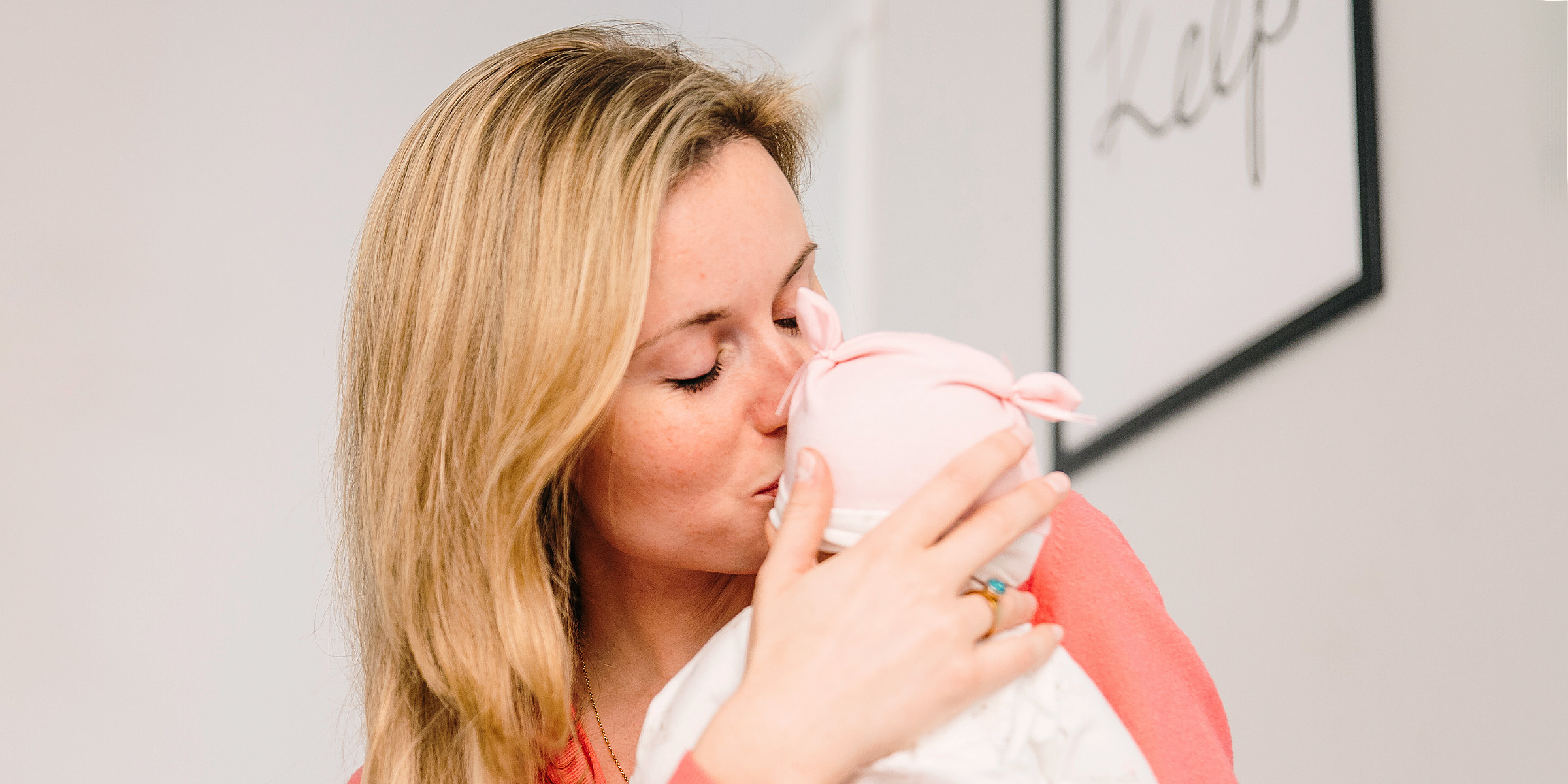 A woman kissing her baby | Source: Freepik