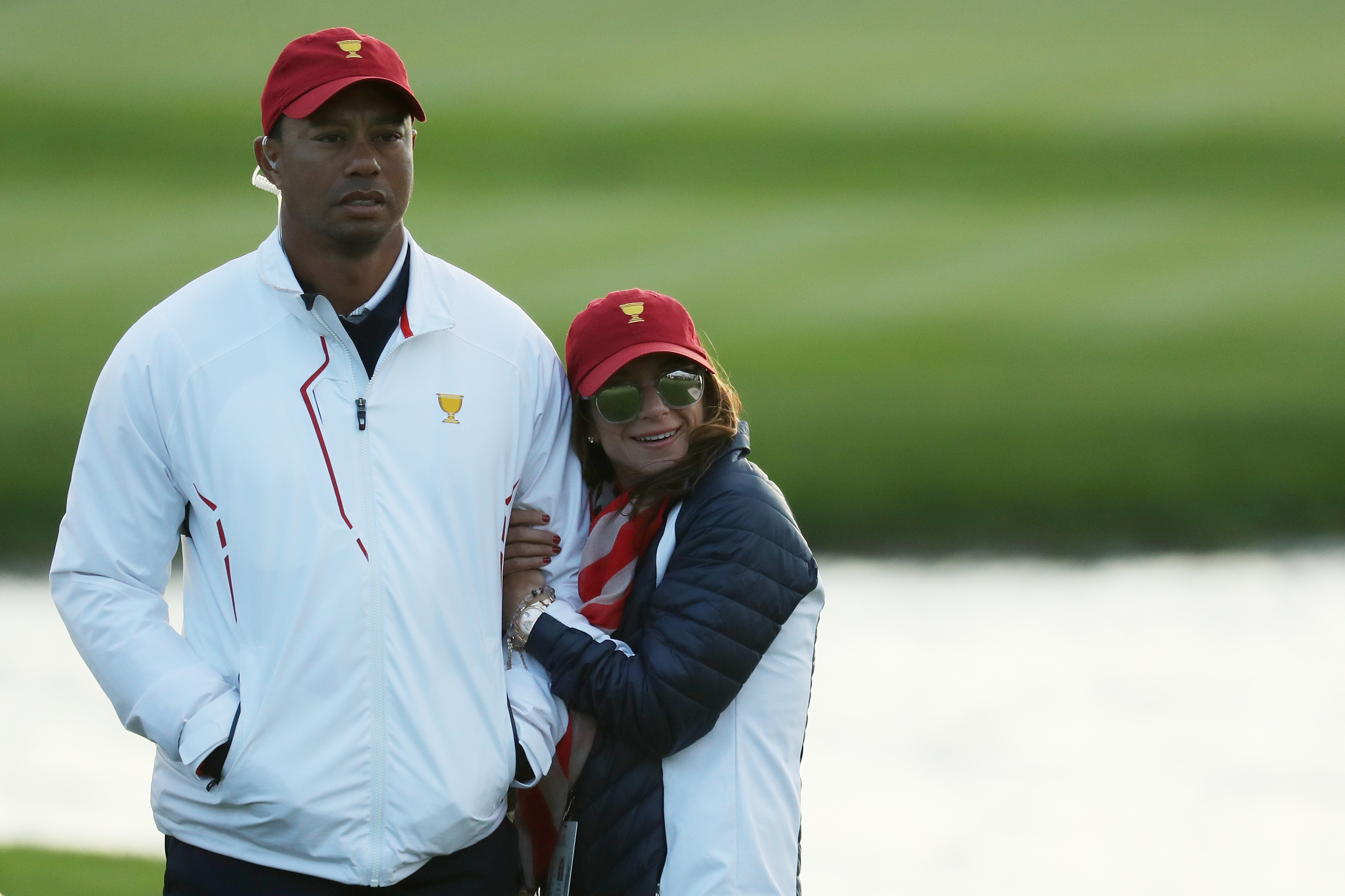 Tiger Woods of the U.S. Team and Erica Herman look on during Saturday four-ball matches of the Presidents Cup on September 30, 2017, at Liberty National Golf Club in Jersey City, New Jersey | Source: Getty Images