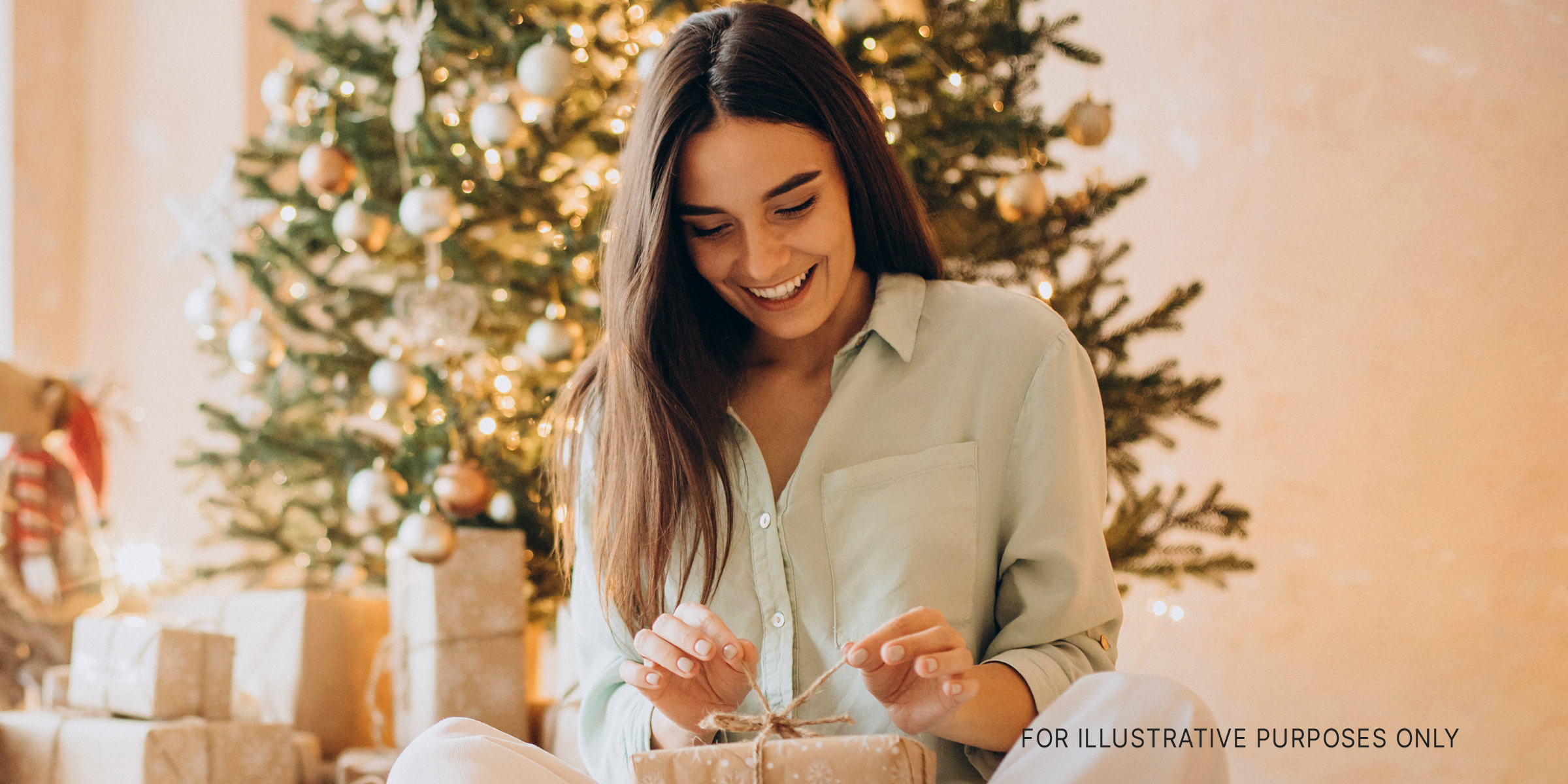 Woman unwrapping a gift | Source: Shutterstock
