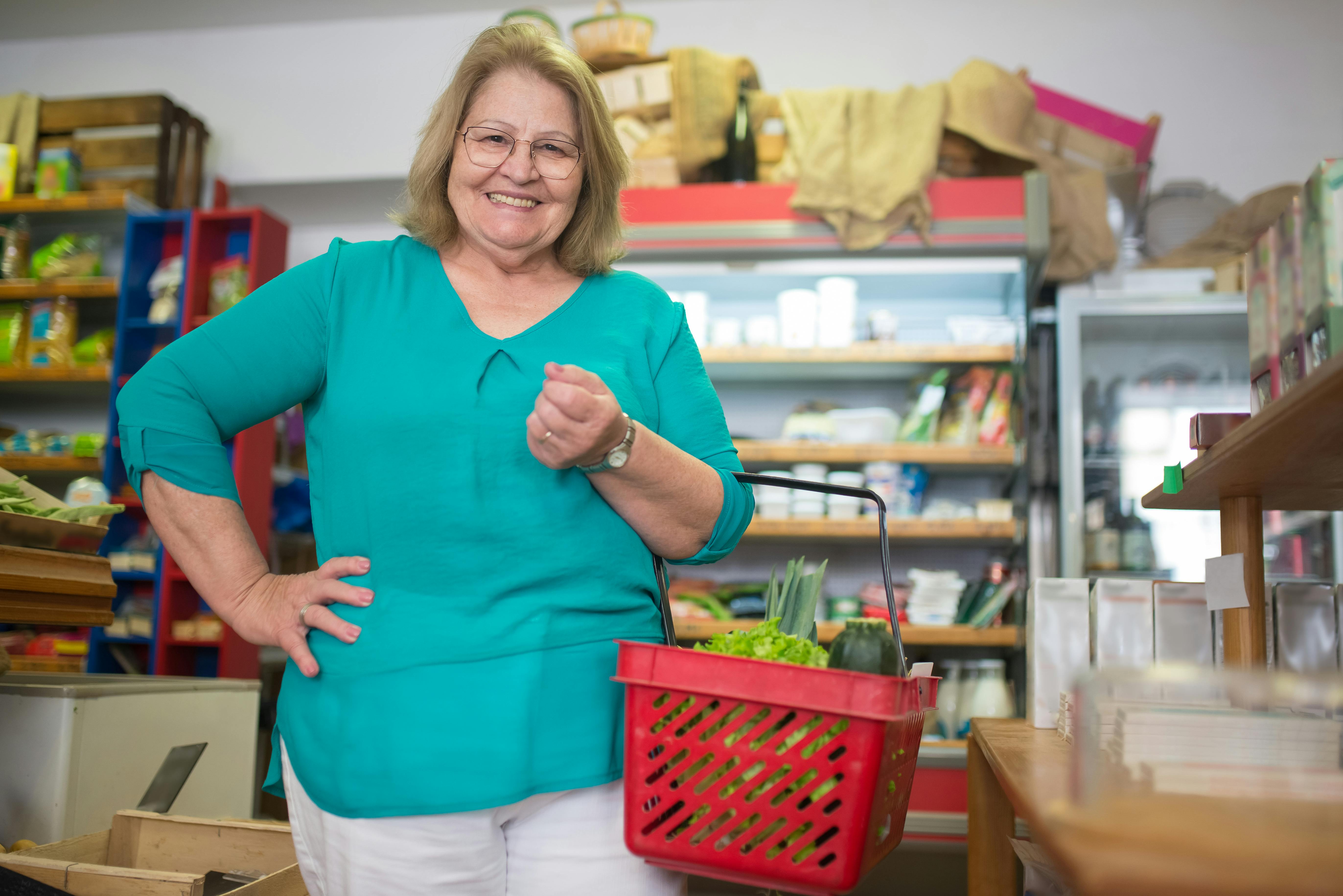 A woman smiling in the grocery store | Source: Pexels