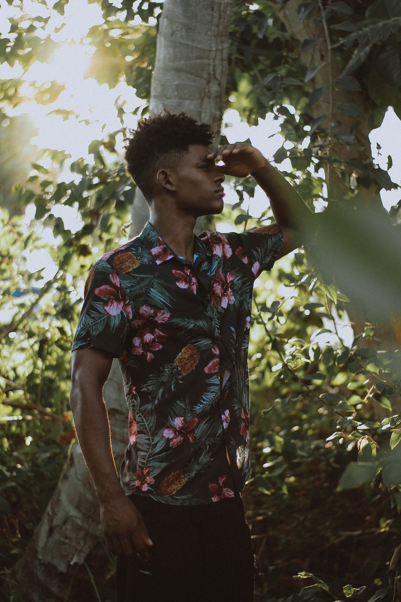 Photo of a man wearing a floral shirt in the woods | Photo: Pexels