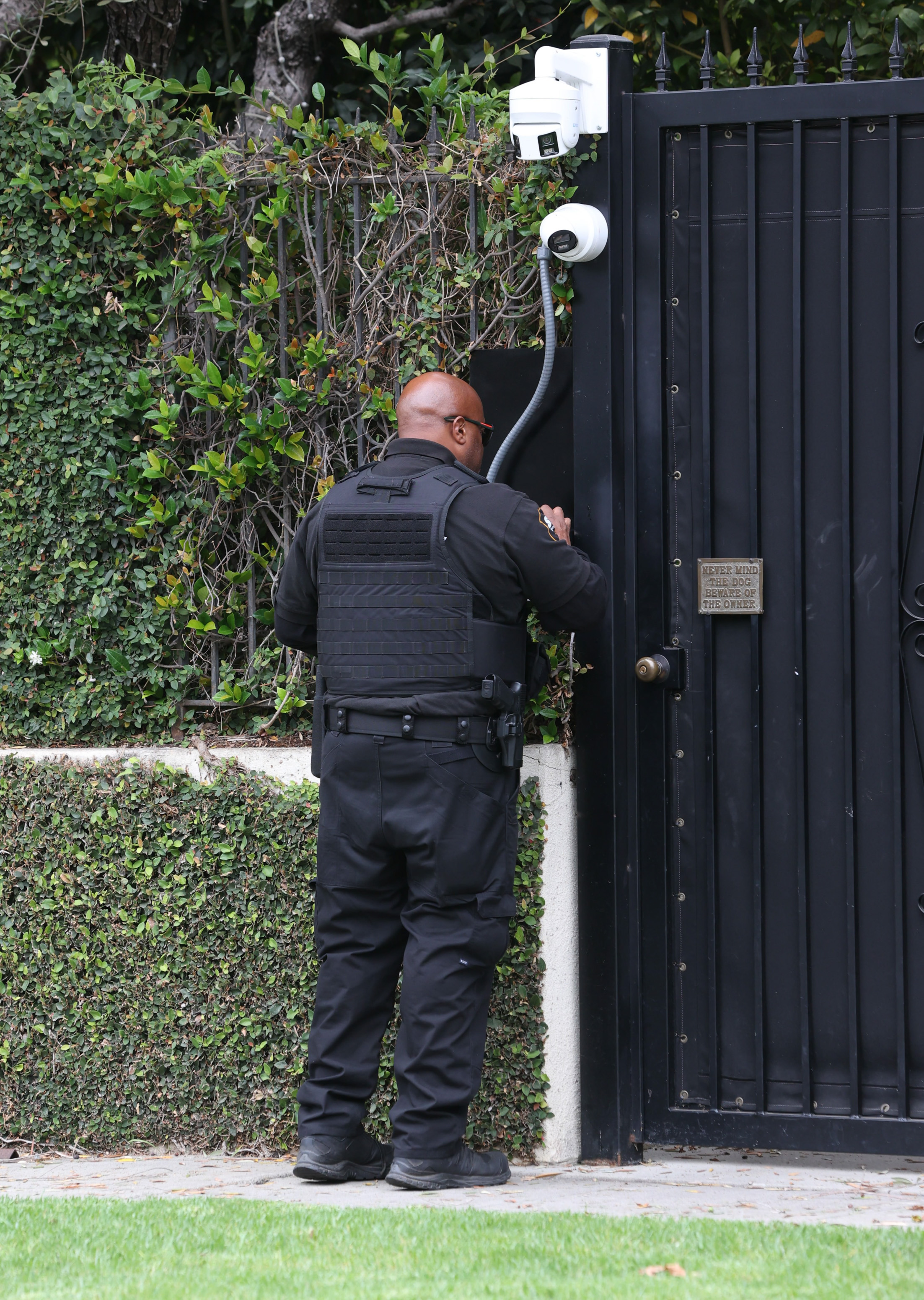 A security guard outside Ozzy Osbourne's Los Angeles home on July 22, 2025, in California. | Source: Getty Images