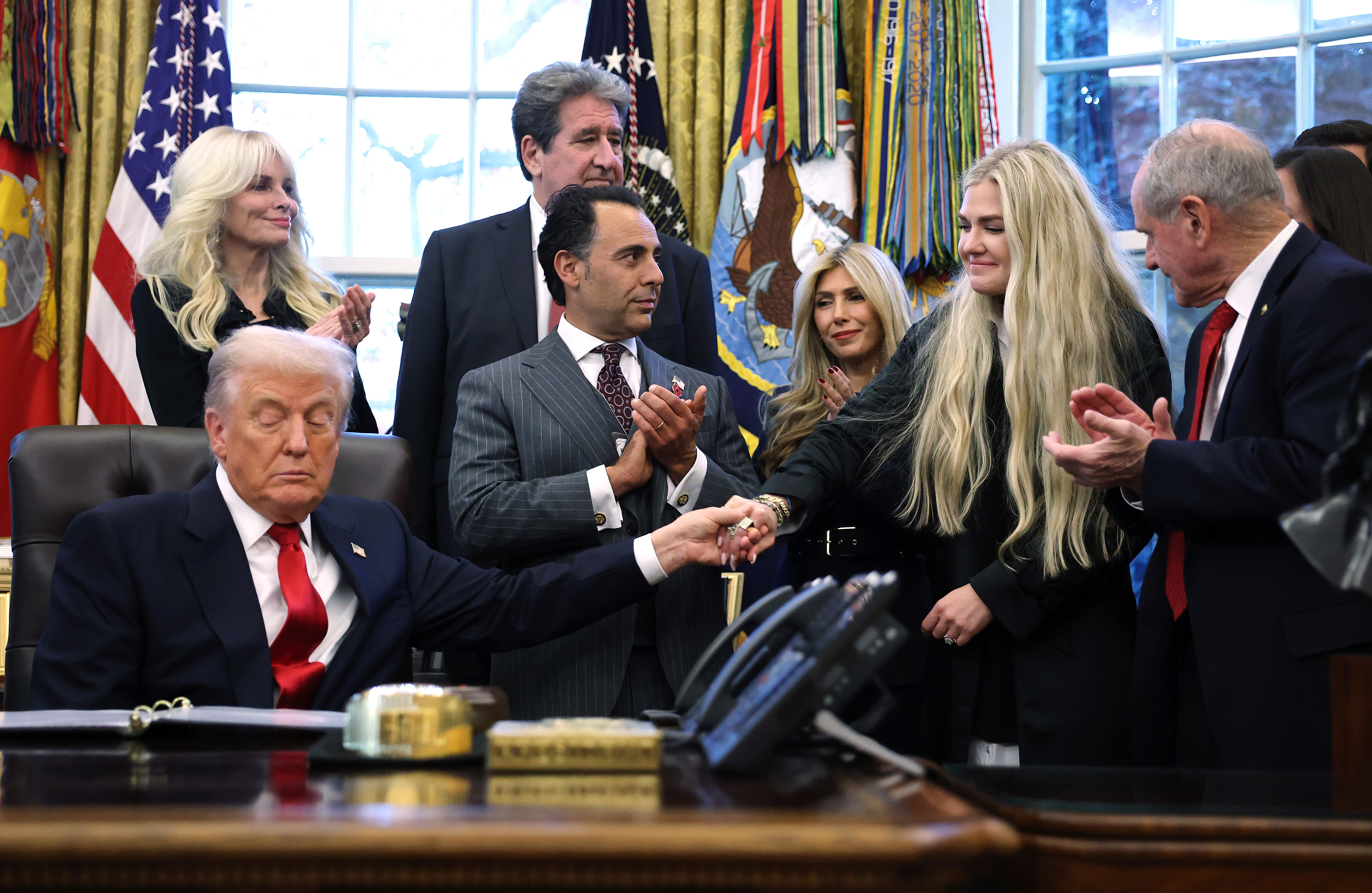 US President Donald Trump and Erika Kirk hold hands during the swearing-in ceremony of US Ambassador to India Sergio Gor in the Oval Office of the White House on November 10, 2025, in Washington, DC | Source: Getty Images