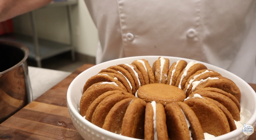 The biscuits were carefully arranged upright and sandwiched with cream to build the structured "gingernut cream" inside the dish. | Source: YouTube/Darren McGrady