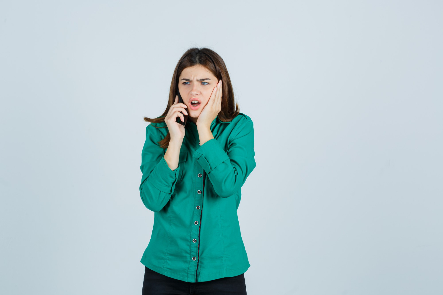 An annoyed woman talking on the phone | Source: Freepik
