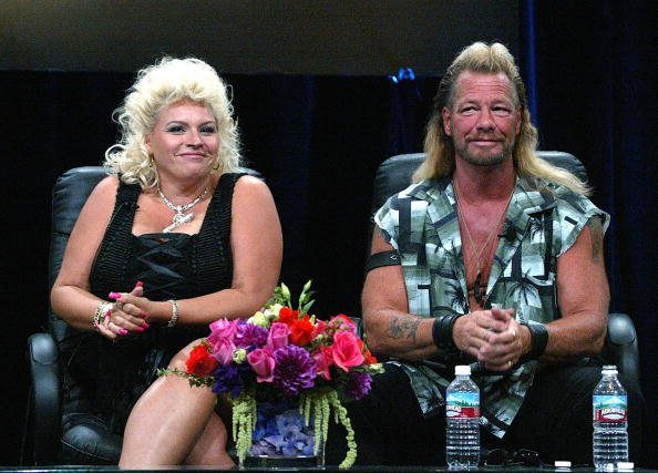 Bounty Hunter Dog Chapman (R) and his wife Beth Chapman of "Dog The Bounty Hunter" speaks with the press at the TCA Press Tour Cable at the Century Plaza Hotel on July 21, 2004, in Los Angeles, California. | Source: Getty Images.