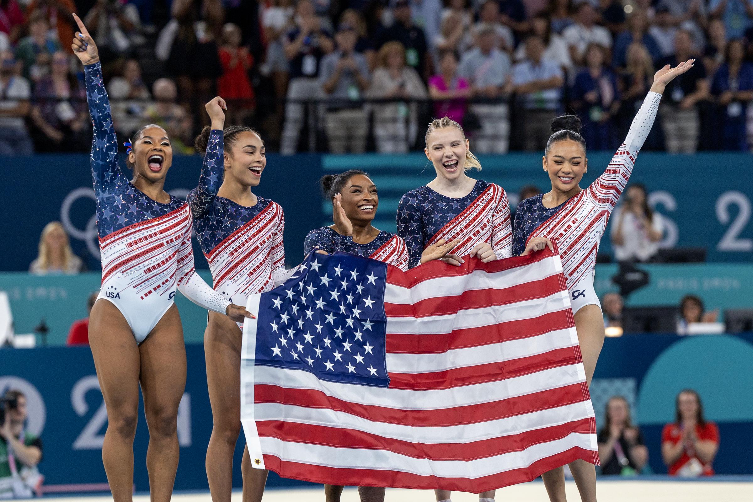 ordan Chiles, Hezly Rivera, Simone Biles, Jade Carey and Suni Lee of the United States celebrate after the team's victory during the Artistic Gymnastics Team Final for Women at the Bercy Arena during the Paris 2024 Summer Olympic Games on July 30th, 2024 in Paris, France | Source: Getty Images