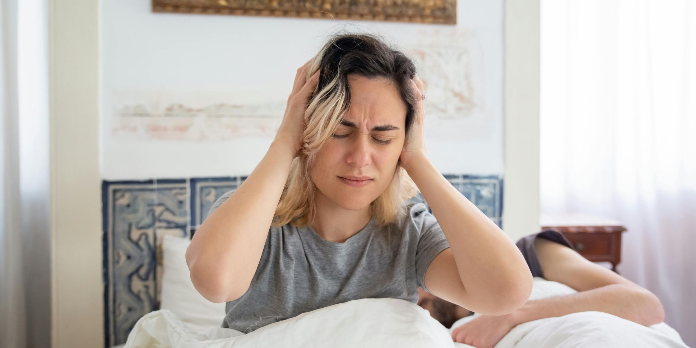 A woman holding her head in pain | Source: Pexels