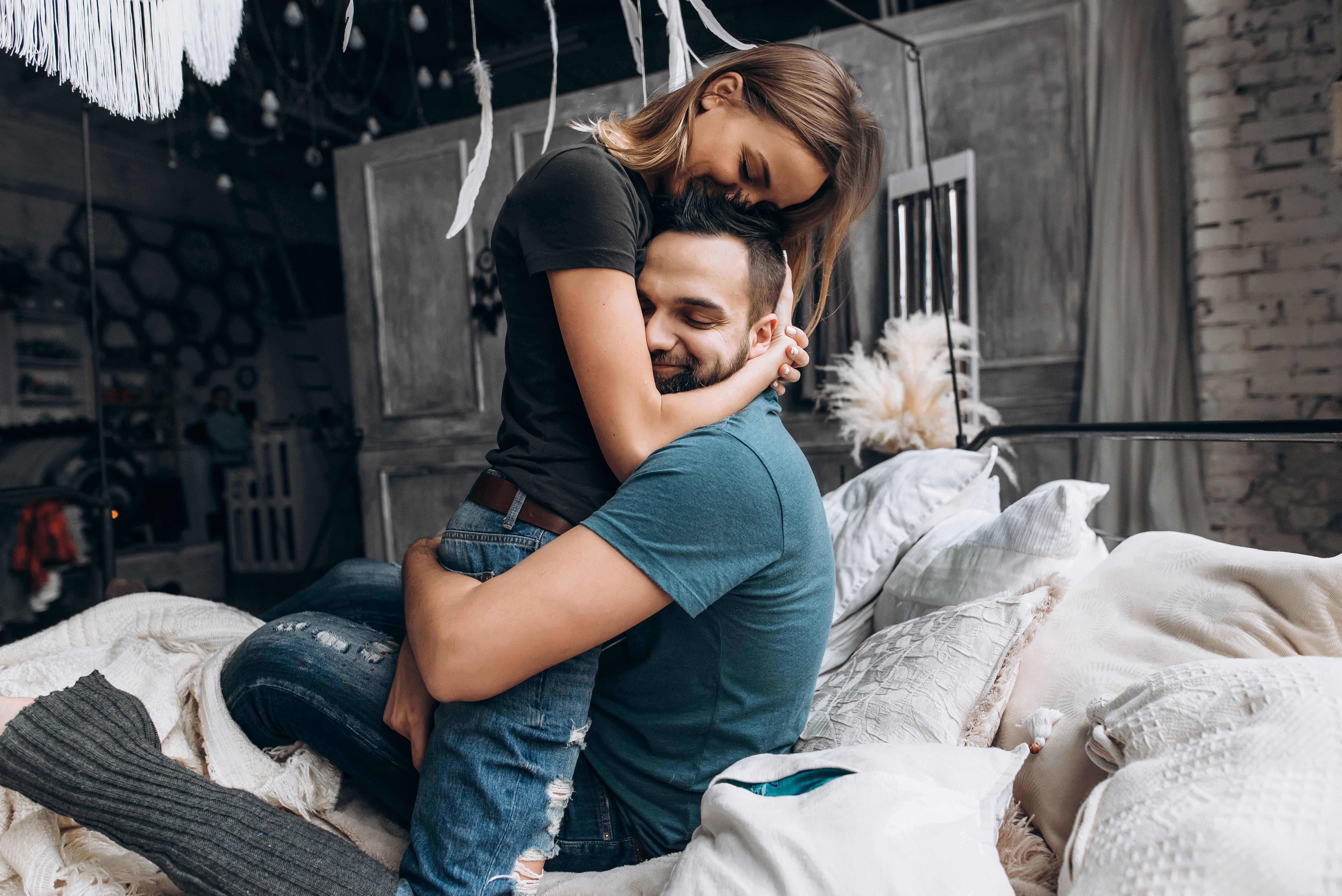 A couple hugging each other in bed. | Source: Getty Images