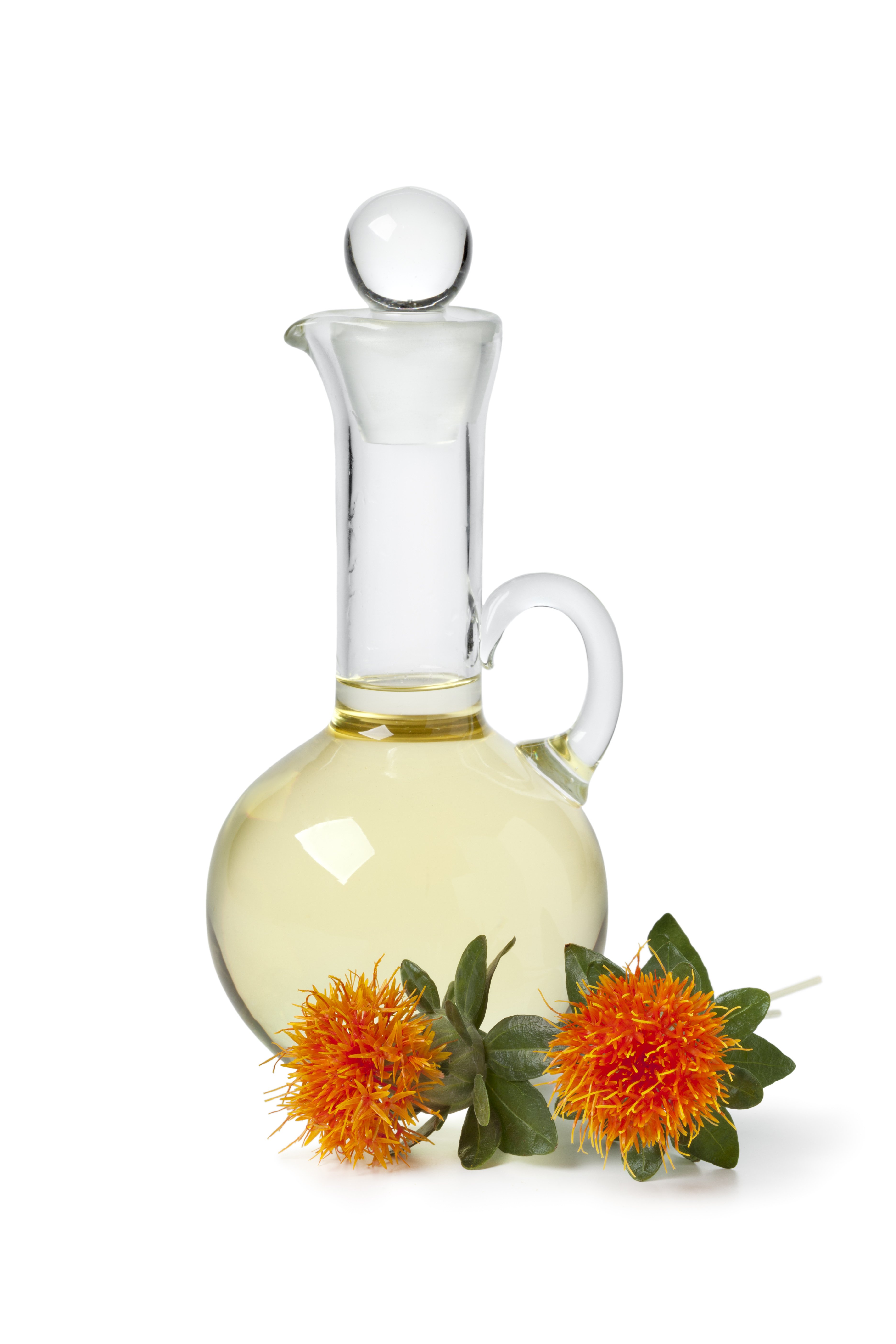 Safflower oil next to safflower flowers | Shutterstock