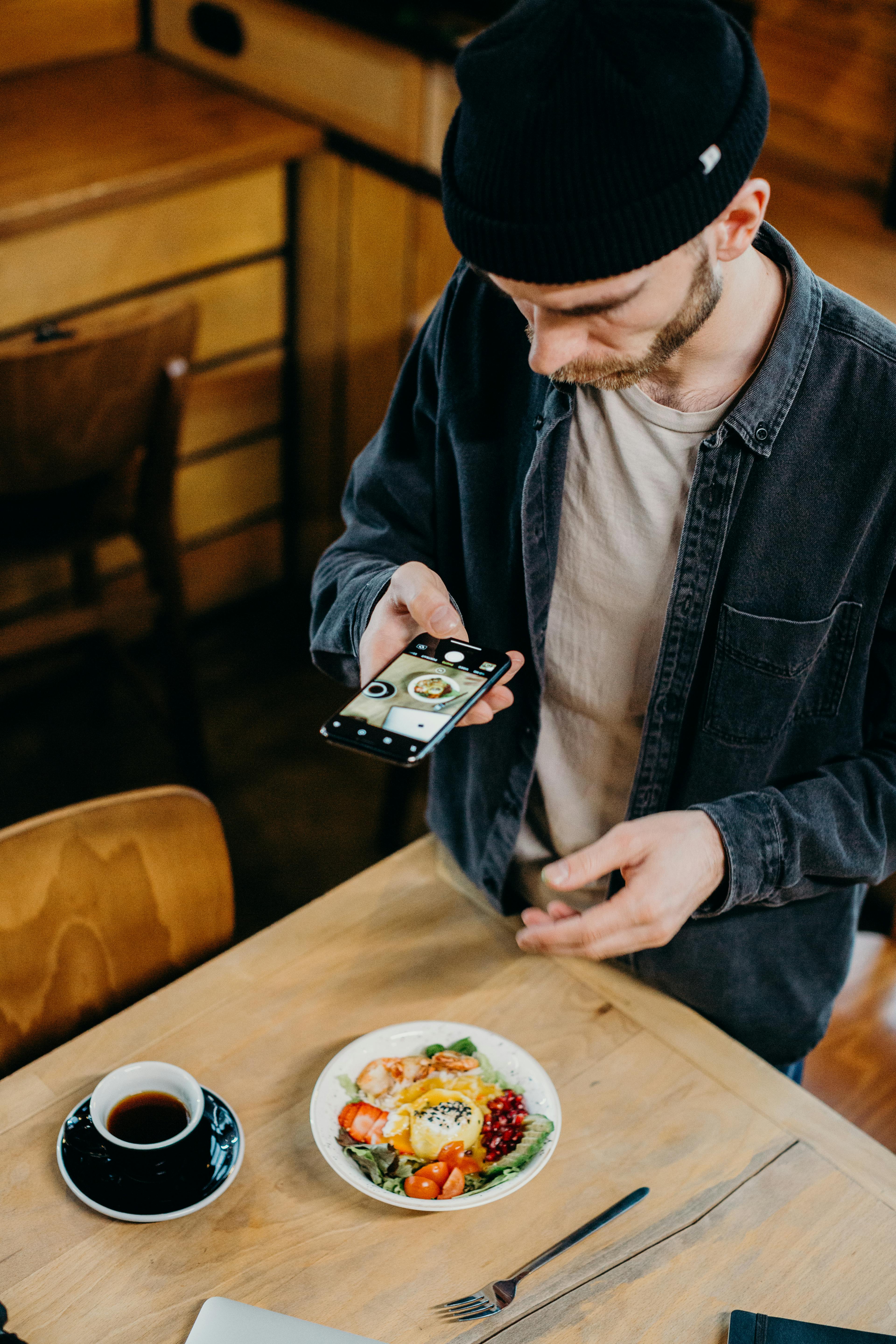 A man taking a photo of a meal | Source: Pexels