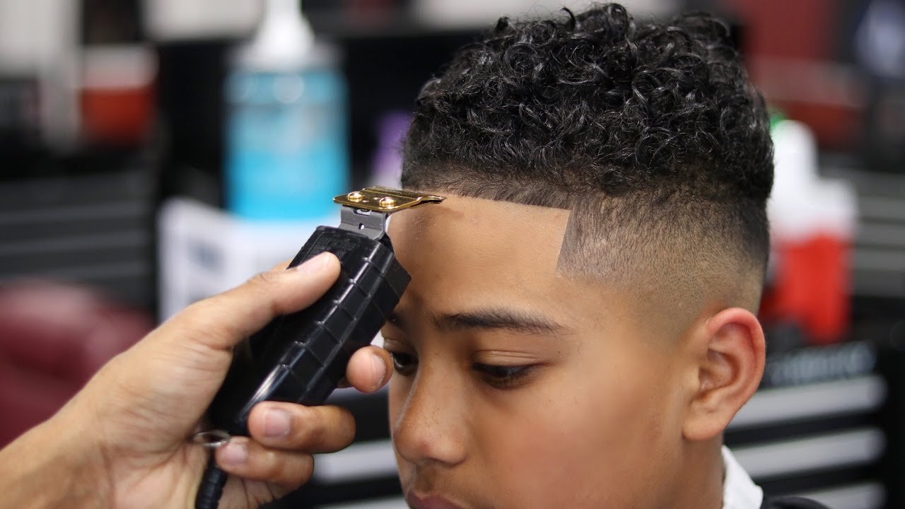 A young boy getting a haircut | Photo: YouTube/360Jeezy