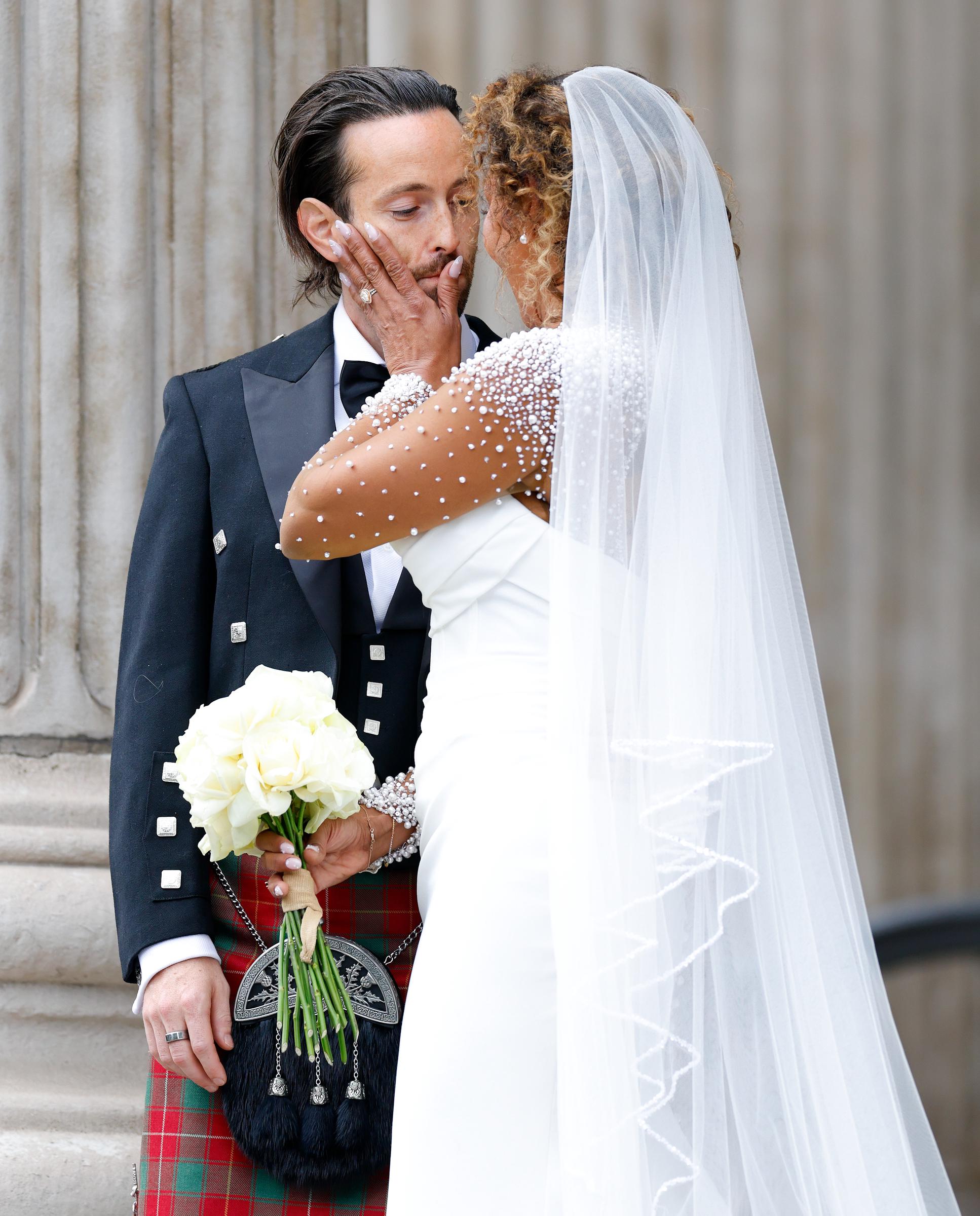 In a tender moment, Mel B is seen gently wiping her husband’s lips after a kiss. The gesture, both affectionate and lighthearted, adds a personal touch to the celebration, capturing the ease and closeness between the newlyweds.
